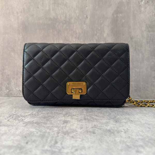 Charles & Keith Cressida Quilted Push-Lock Clutch Bag in black faux leather with gold-tone chain strap and secure push-lock closure.