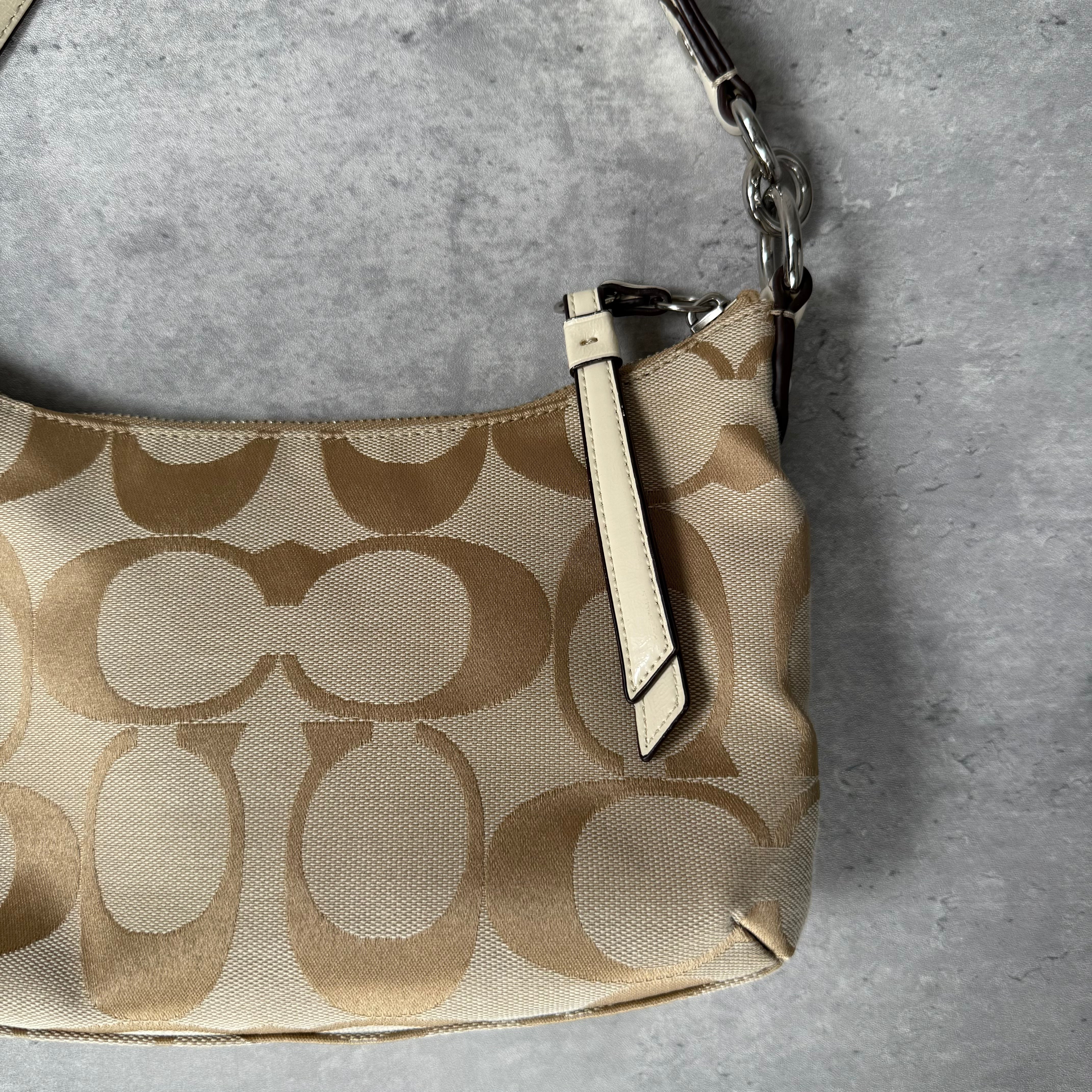 Coach 2-Way Signature Stripe Shoulder Bag in Beige and White with detachable strap, zip closure, and central white leather stripe with metal Coach emblem