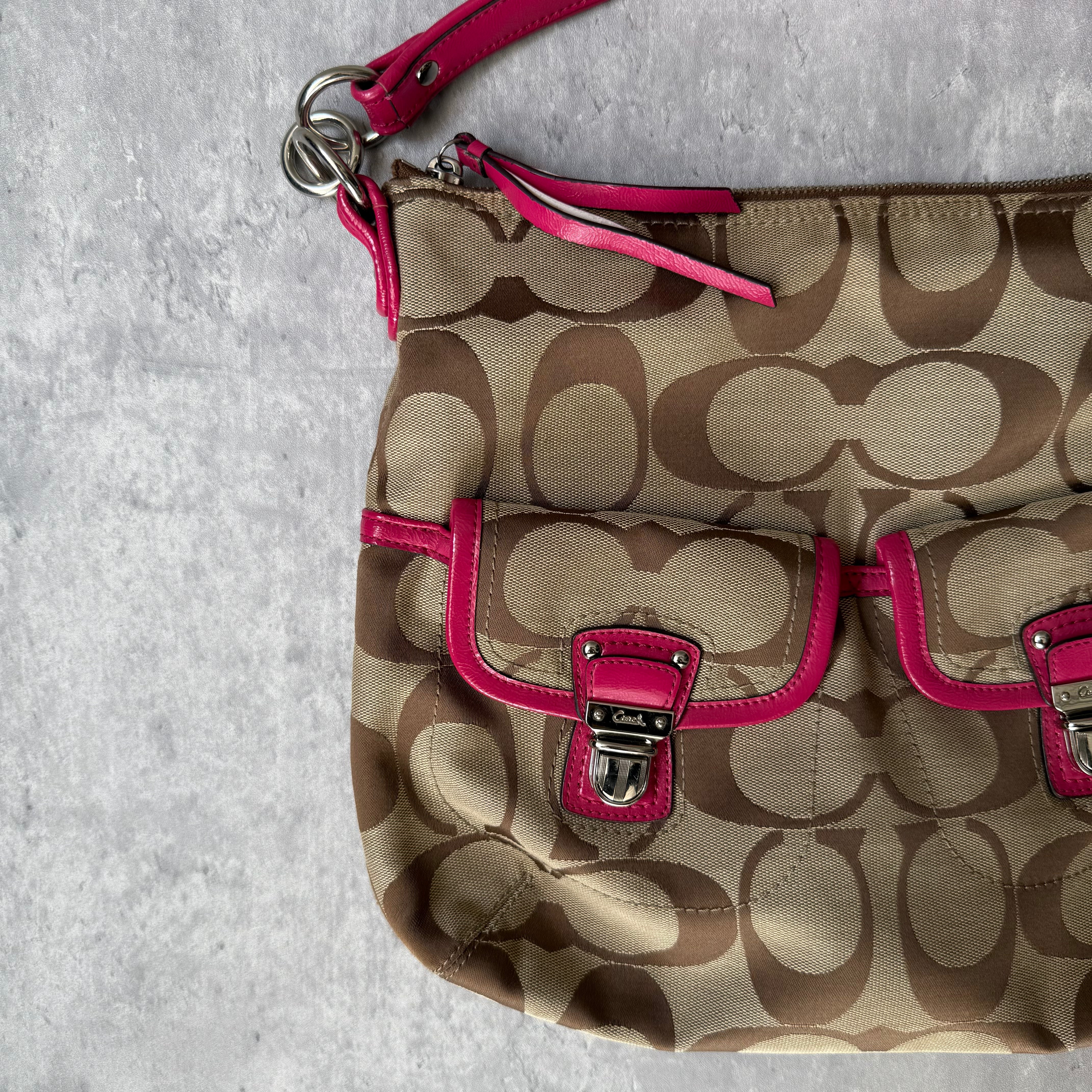 Coach 2Way Signature Pocket Hobo Daisy Bag in beige canvas with pink leather trim, dual front pockets, and detachable strap.