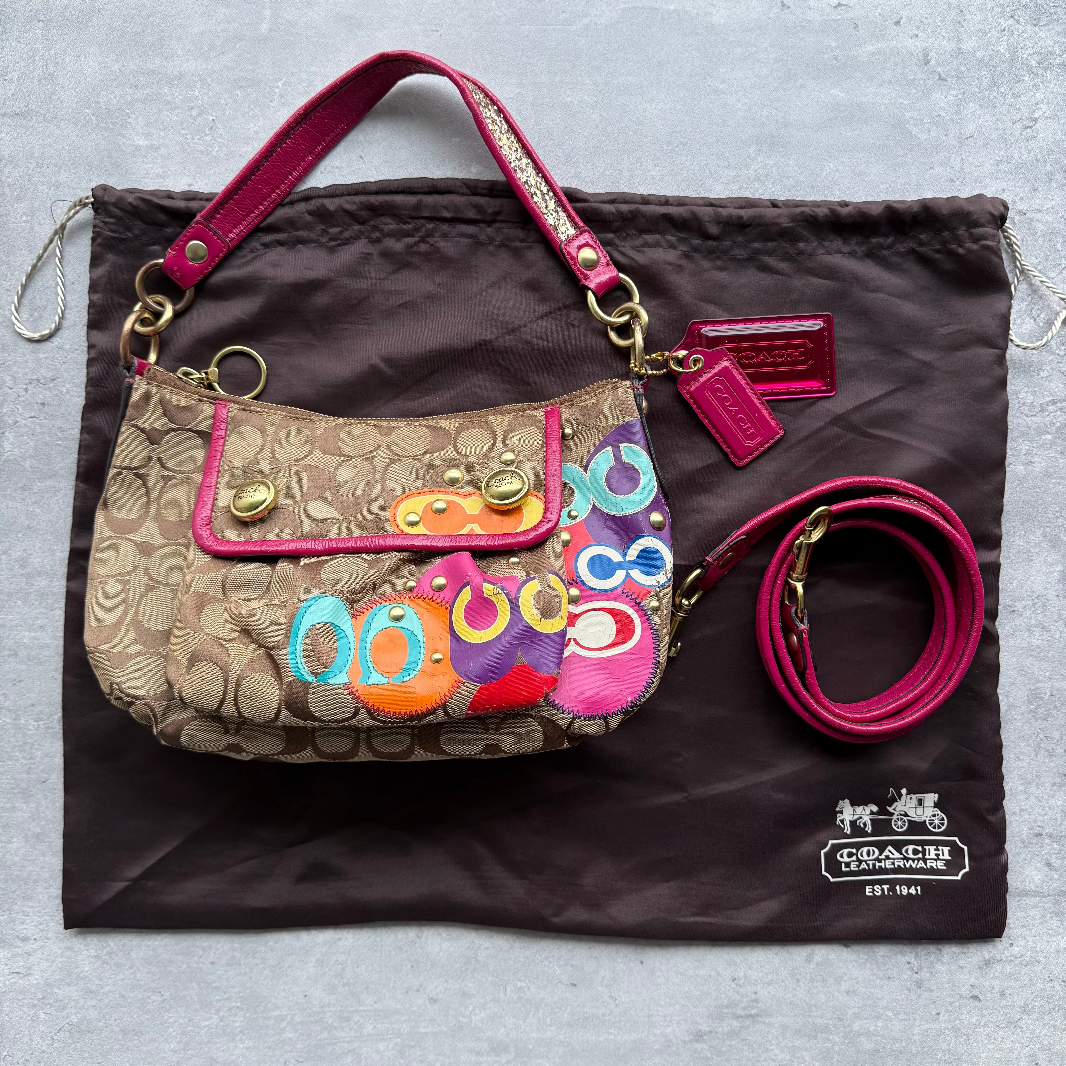 Coach 2Way Signature Poppy Glitter Shoulder Bag in beige jacquard with multicolor appliqué, pink leather trim, gold-tone hardware, and detachable crossbody strap.