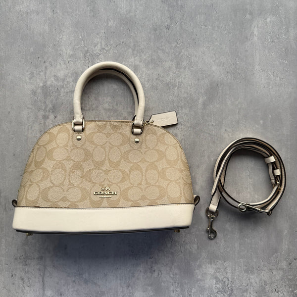 Coach 2Way Signature Sierra Hand Bag in beige monogram coated canvas with cream leather trim, gold-tone hardware, and detachable strap.