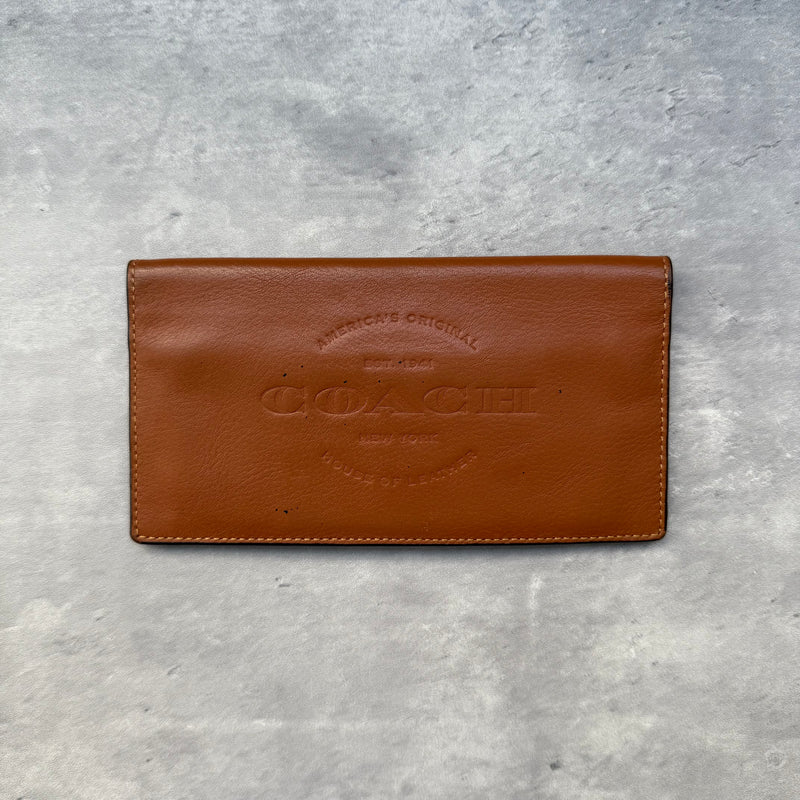 Coach Breast Pocket Wallet Brown, crafted in smooth leather with embossed Coach logo and multiple interior card slots.
