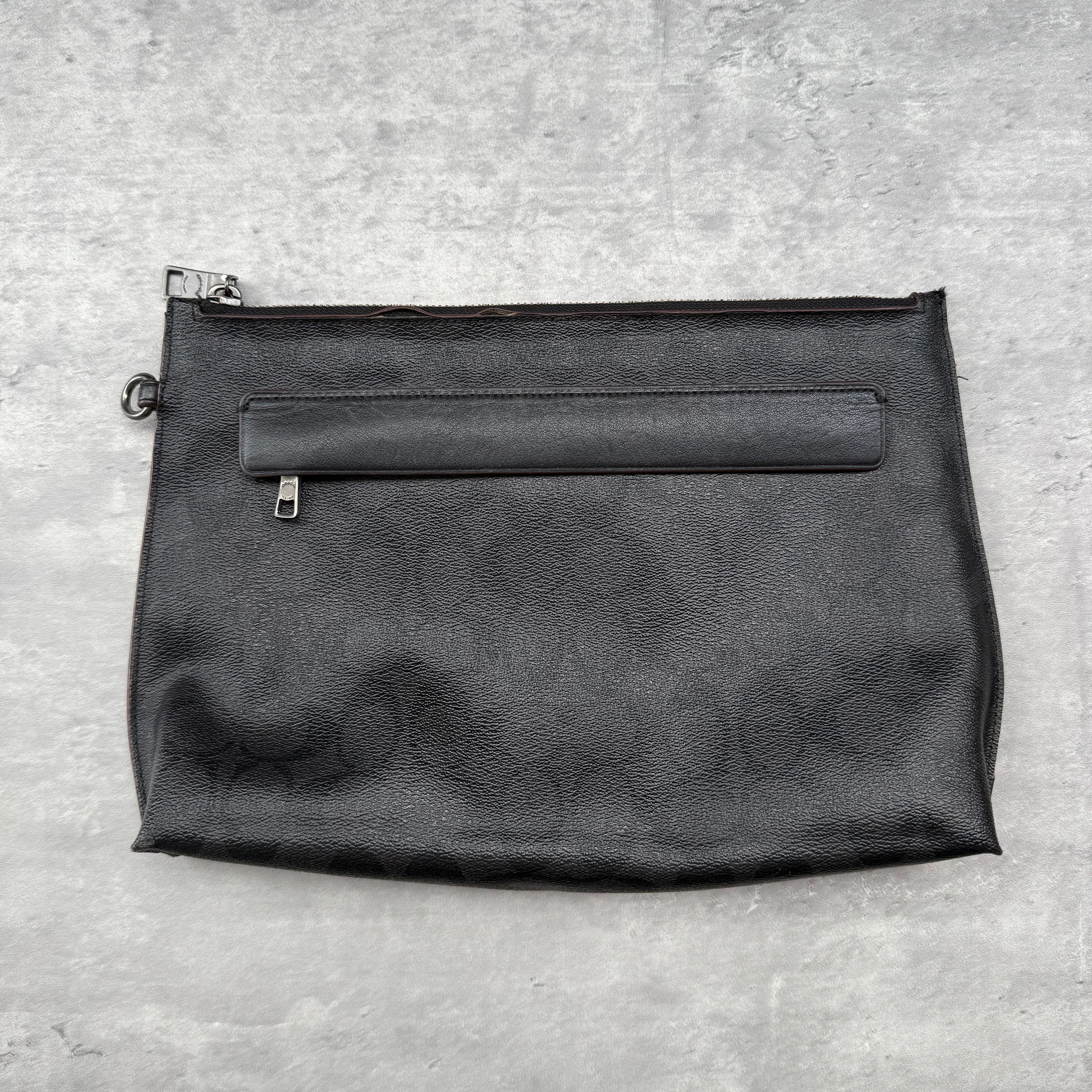 Coach Carryall Black Leather Pouch with zip closure, back pocket, and fabric-lined interior