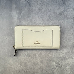 Coach Crossgrain Leather Zip Wallet Chalk White, featuring a zip-around design, external pocket, and gold-tone logo.