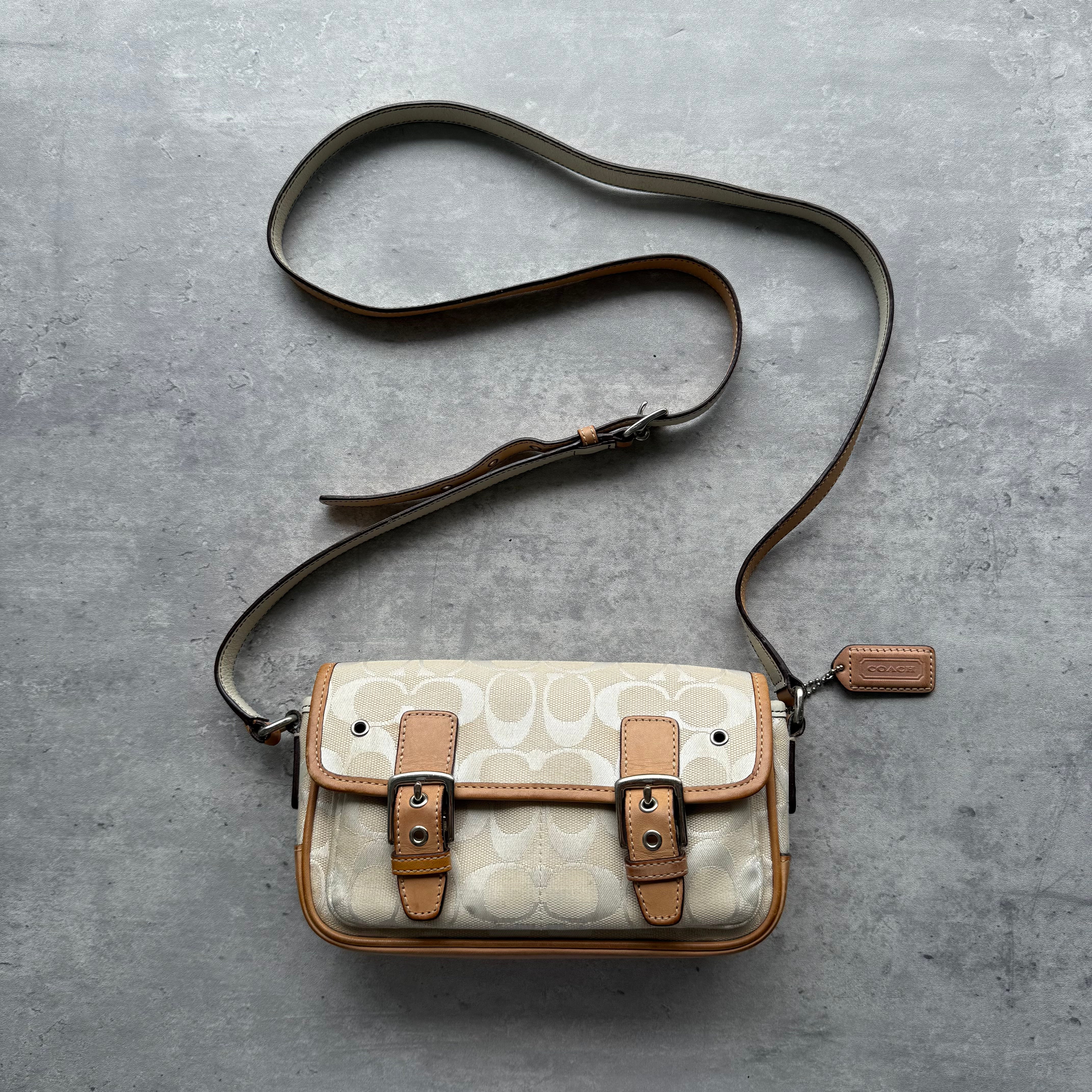 Coach Double Buckle Mini Crossbody Bag in cream signature canvas with tan leather trim and adjustable strap.