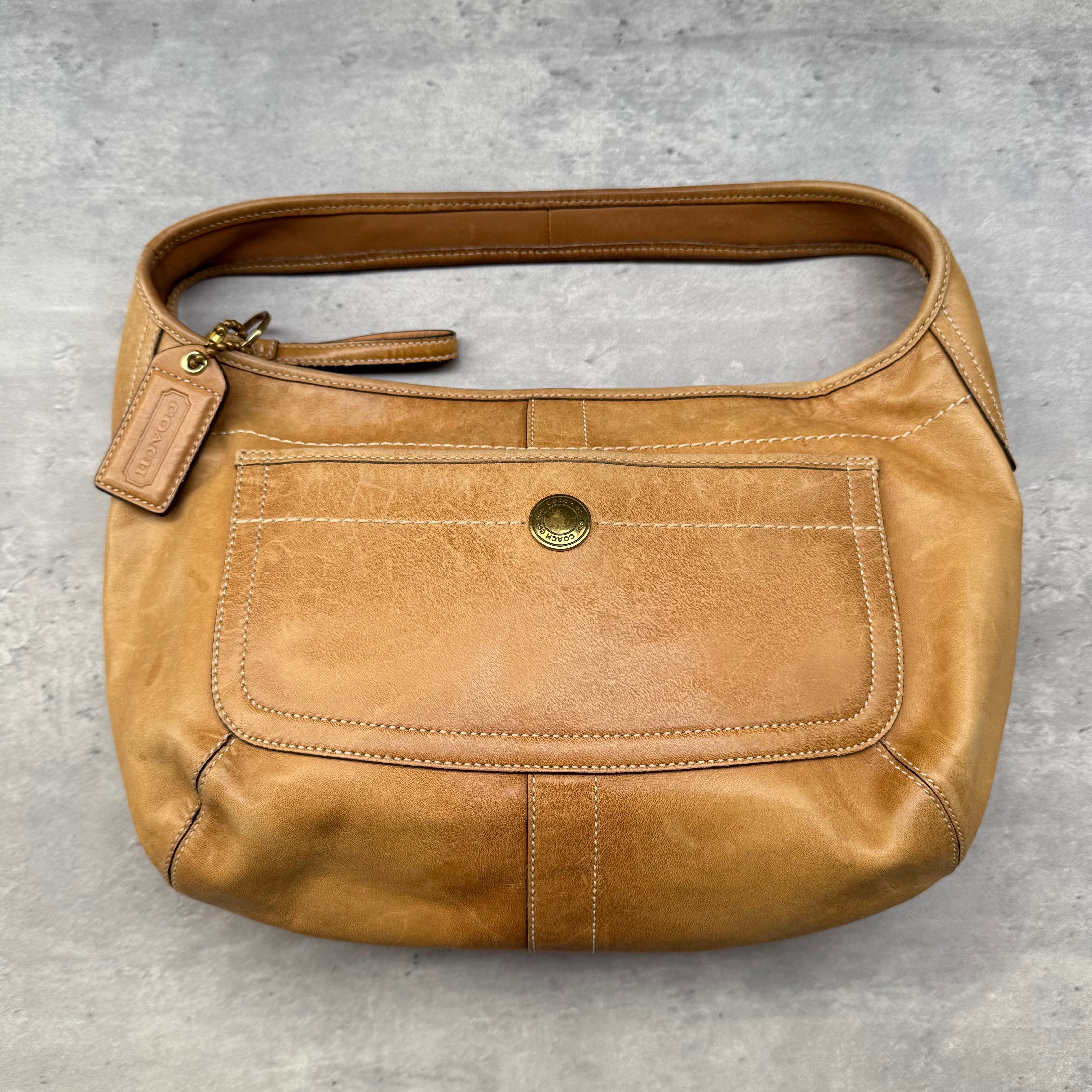 Coach Ergo Hobo Leather Shoulder Bag in tan smooth leather with brass-tone hardware and zip closure.