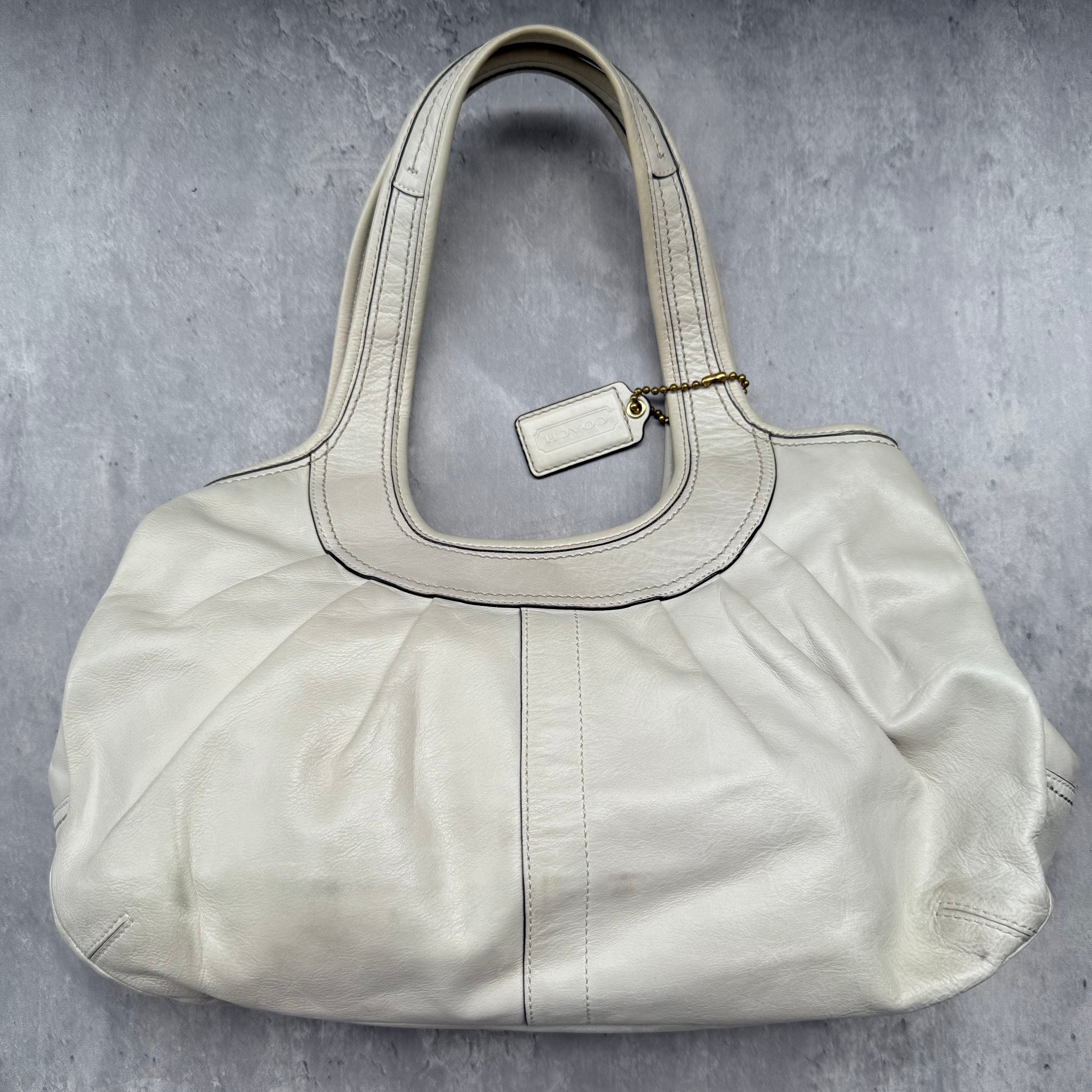 Coach Ergo Kisslock Shoulder Bag in white leather with brass-tone hardware and plaid interior lining.