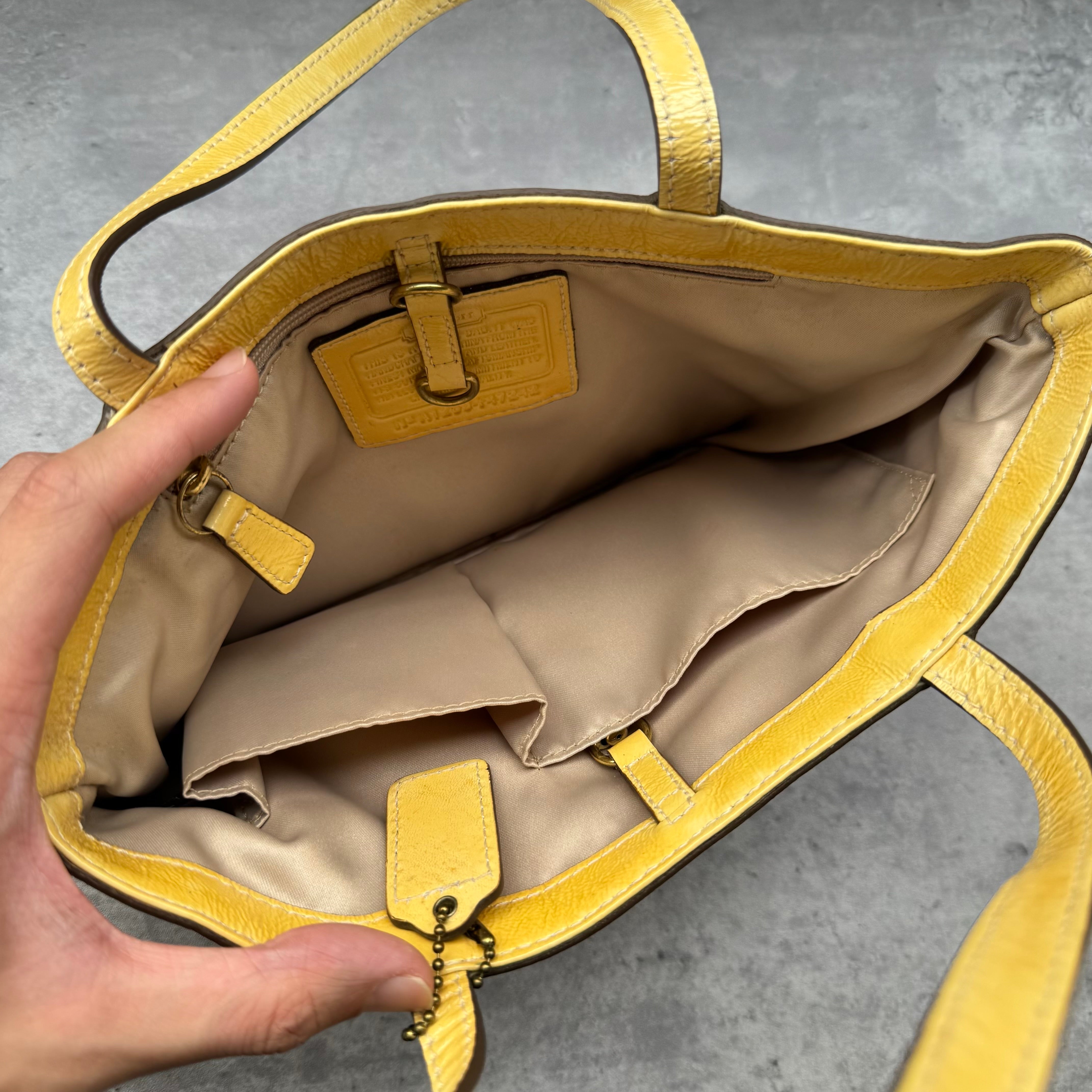 Coach Floral Applique Tote Bag in beige signature canvas with yellow leather trim and pastel leather flower details.