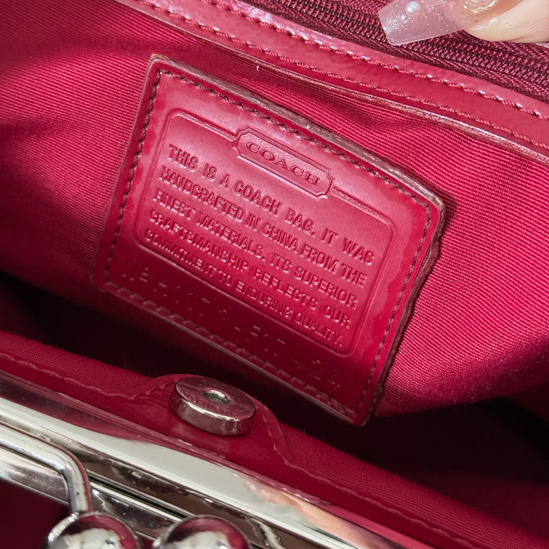 Coach Framed Kiss Lock Carryall Satchel in tan and red stripe with signature monogram canvas, silver-tone hardware, and spacious red fabric-lined interior.