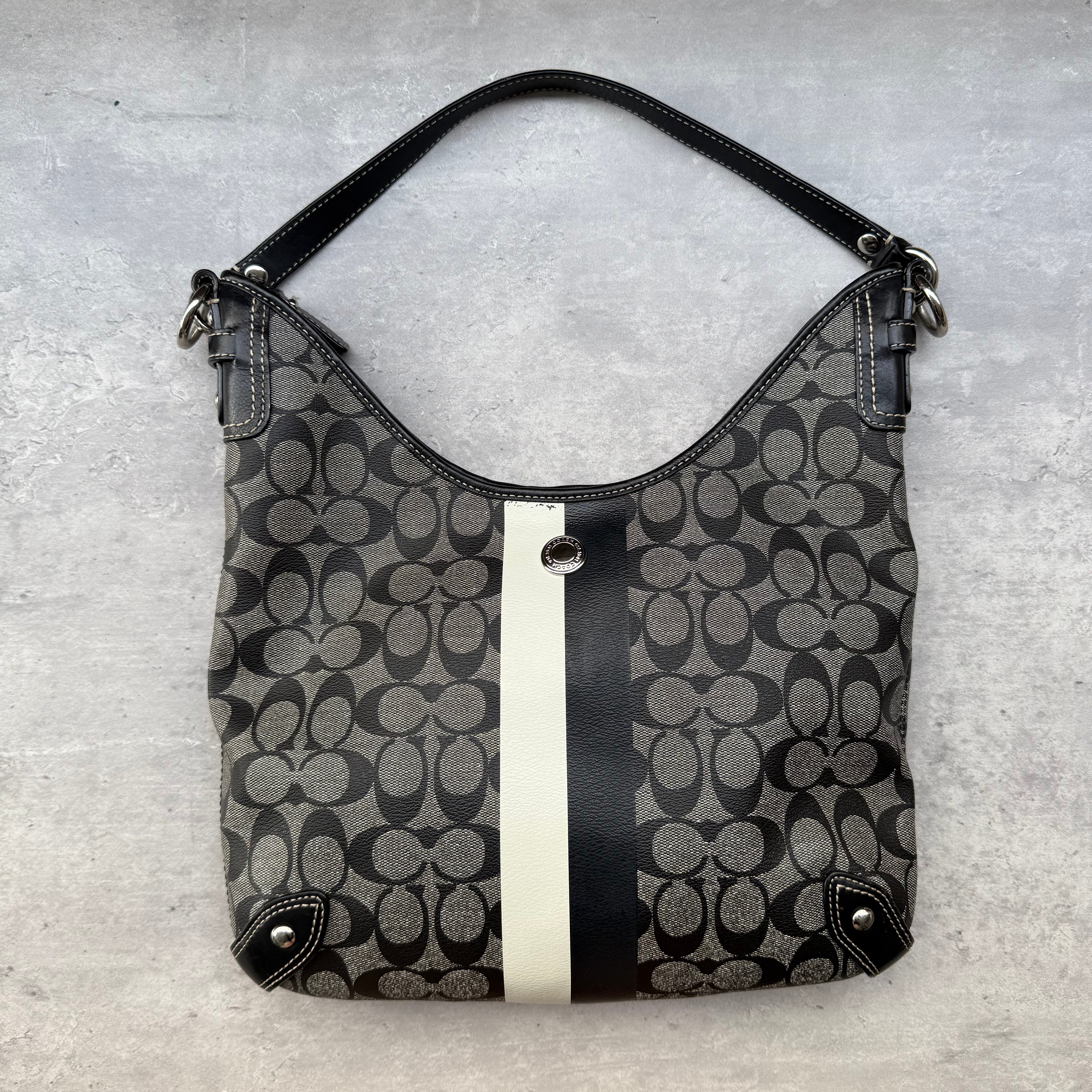 Coach Heritage Stripe Chelsea Hobo Shoulder Bag in black/grey signature canvas with ivory stripe, silver-tone hardware, and blue interior lining.