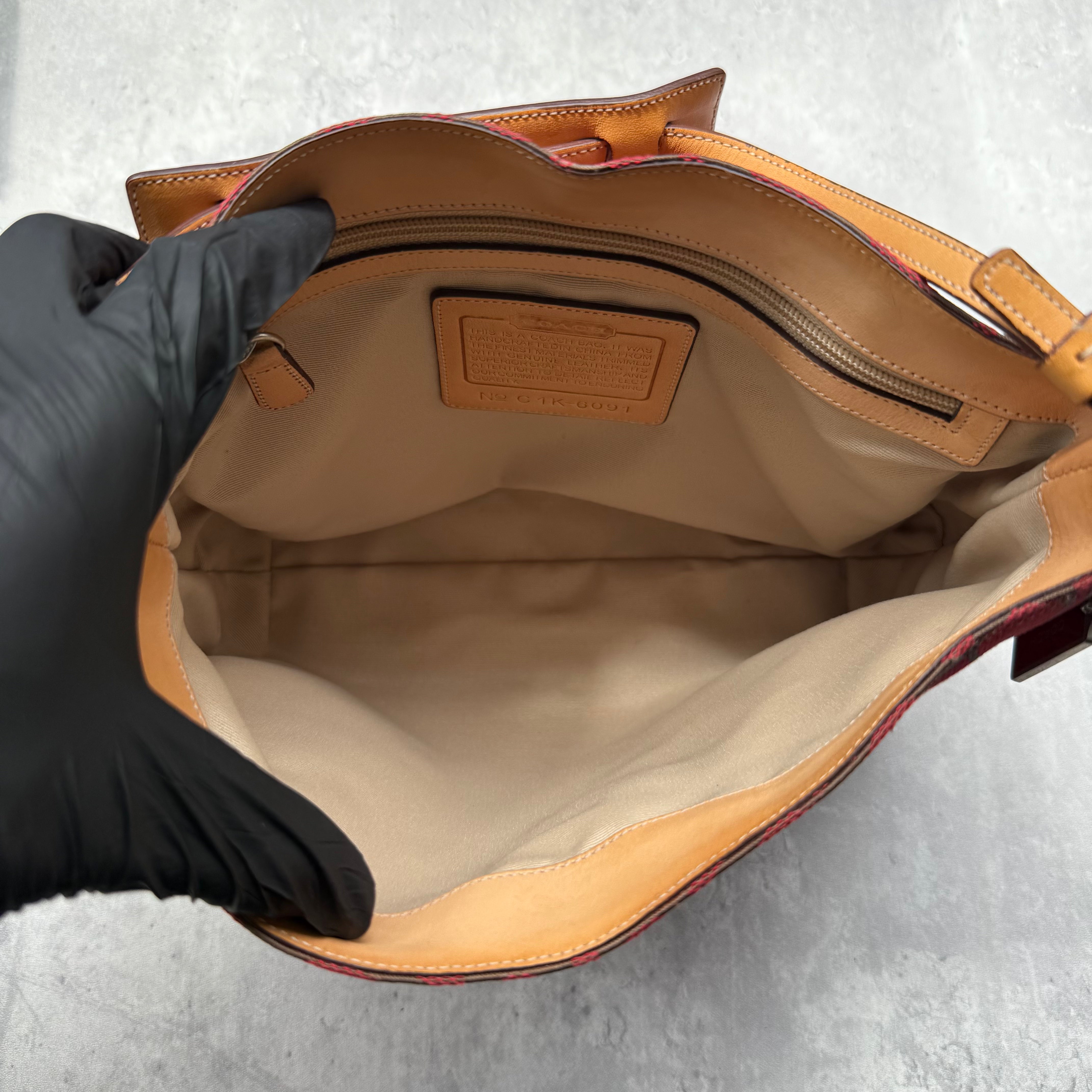 Coach Hobo Signature Clip Canvas Handbag in red monogram canvas with beige leather trim, front clip detail, and beige interior.