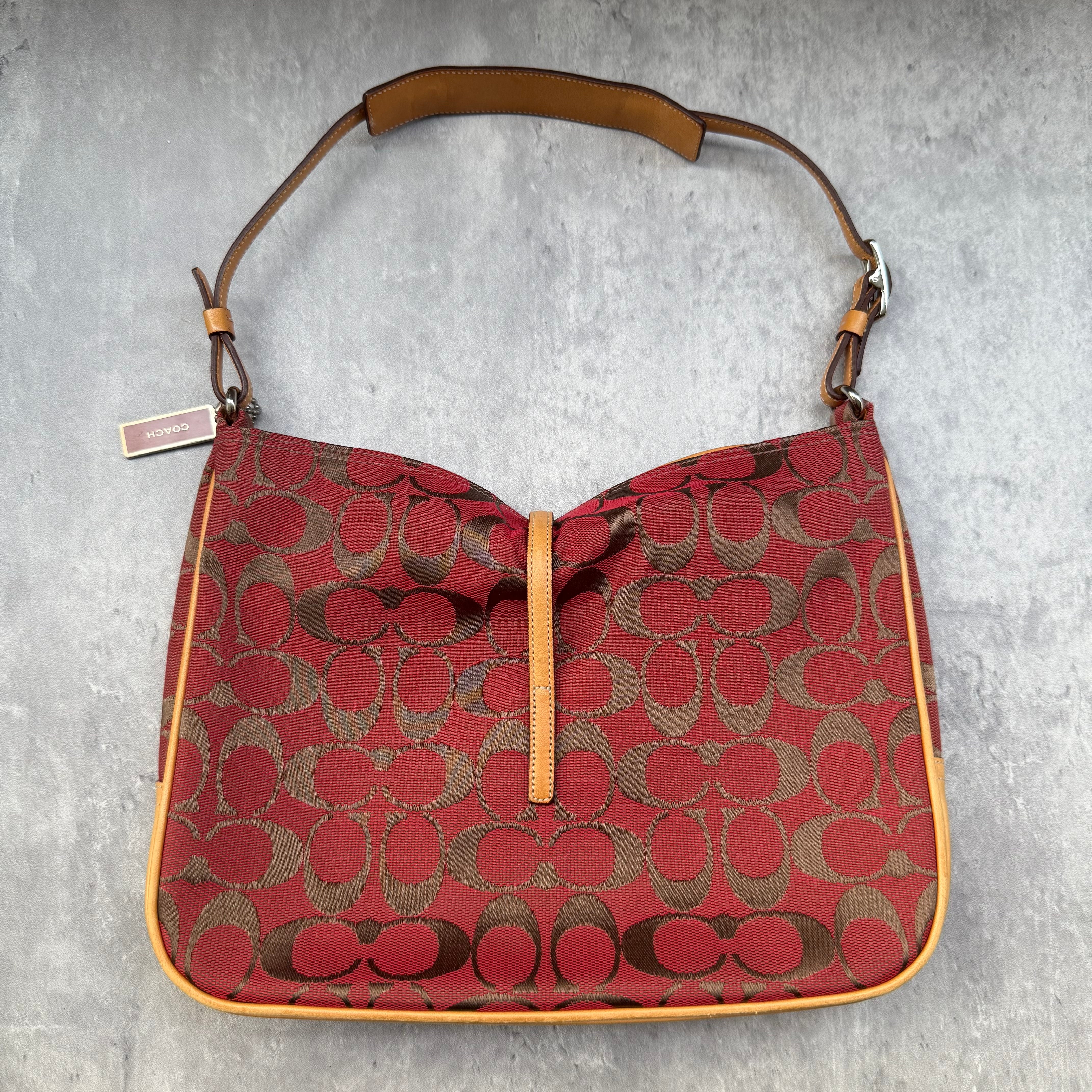 Coach Hobo Signature Clip Canvas Handbag in red monogram canvas with beige leather trim, front clip detail, and beige interior.