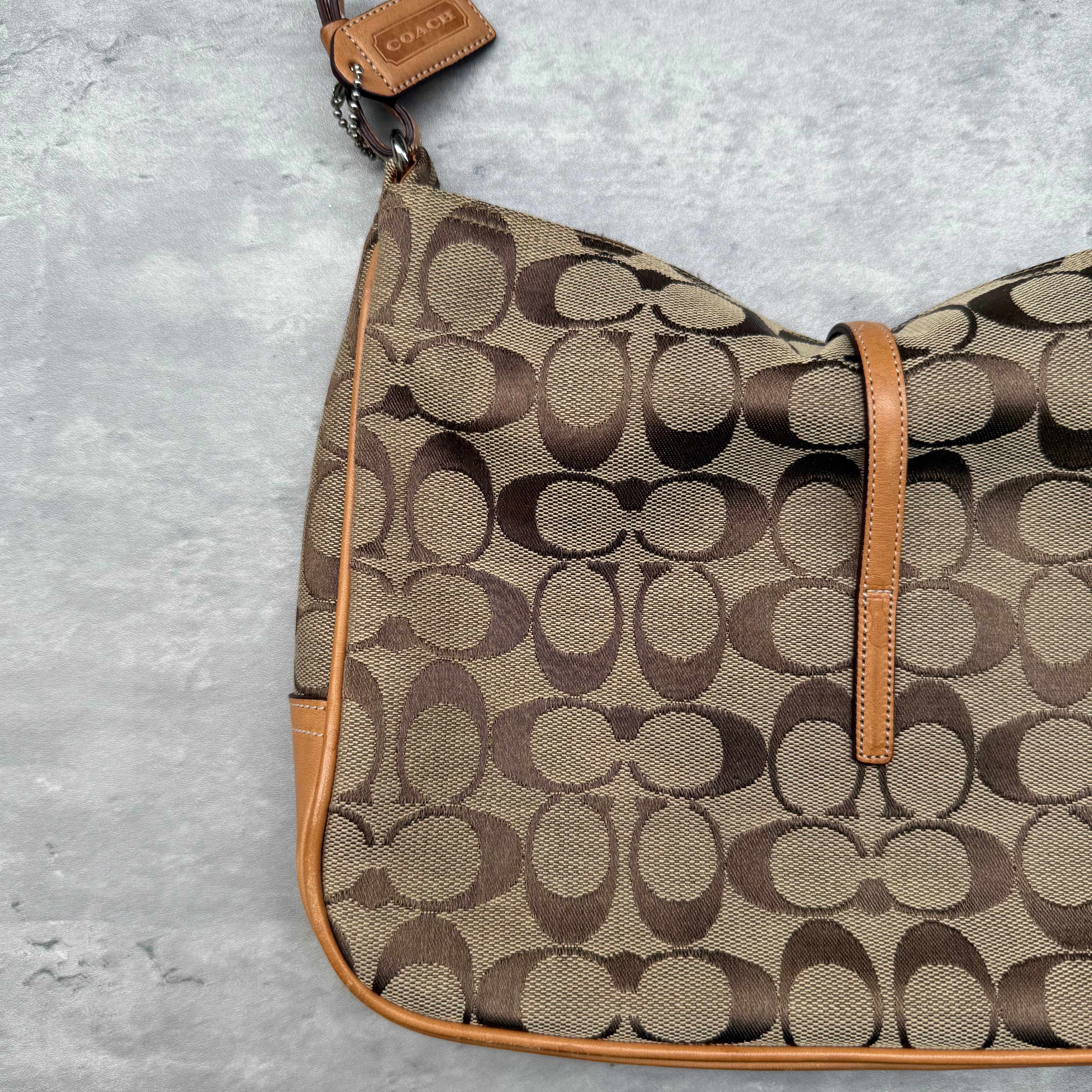 Coach Hobo Signature Clip Canvas Handbag Beige with monogram jacquard canvas, tan leather trim, front clip accent, and red-orange interior lining