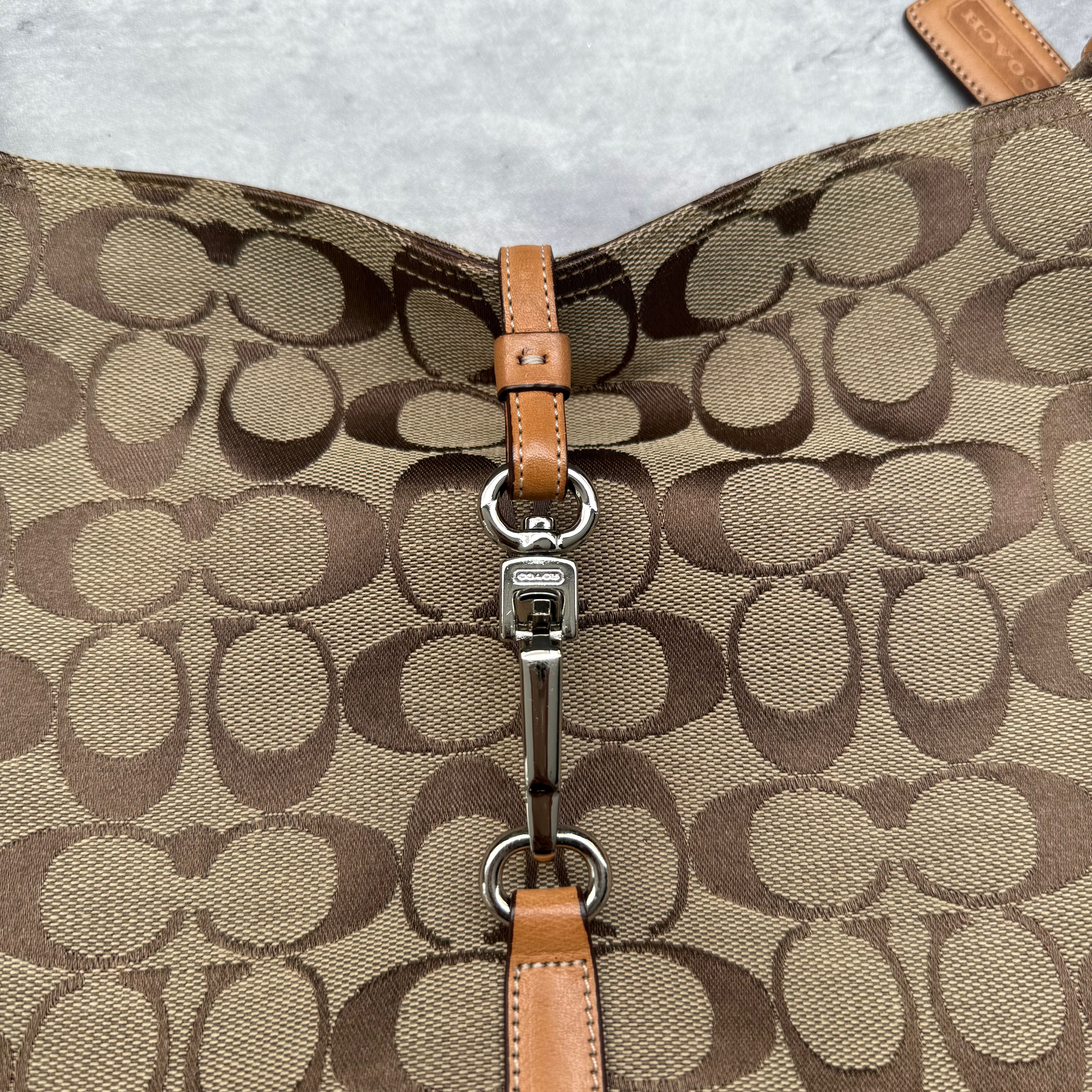 Coach Hobo Signature Clip Canvas Handbag Beige with monogram jacquard canvas, tan leather trim, front clip accent, and red-orange interior lining