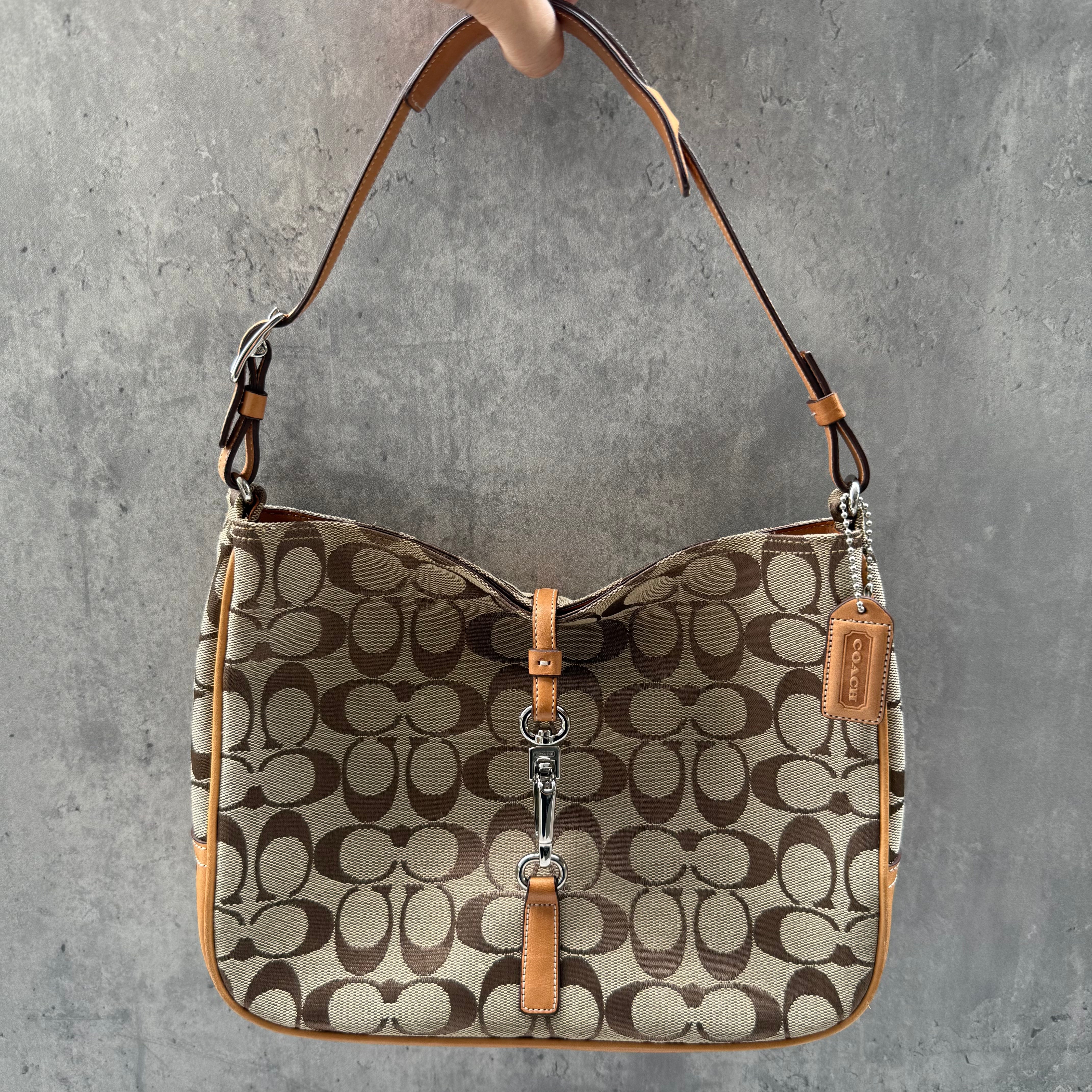 Coach Hobo Signature Clip Canvas Handbag Beige with monogram jacquard canvas, tan leather trim, front clip accent, and red-orange interior lining