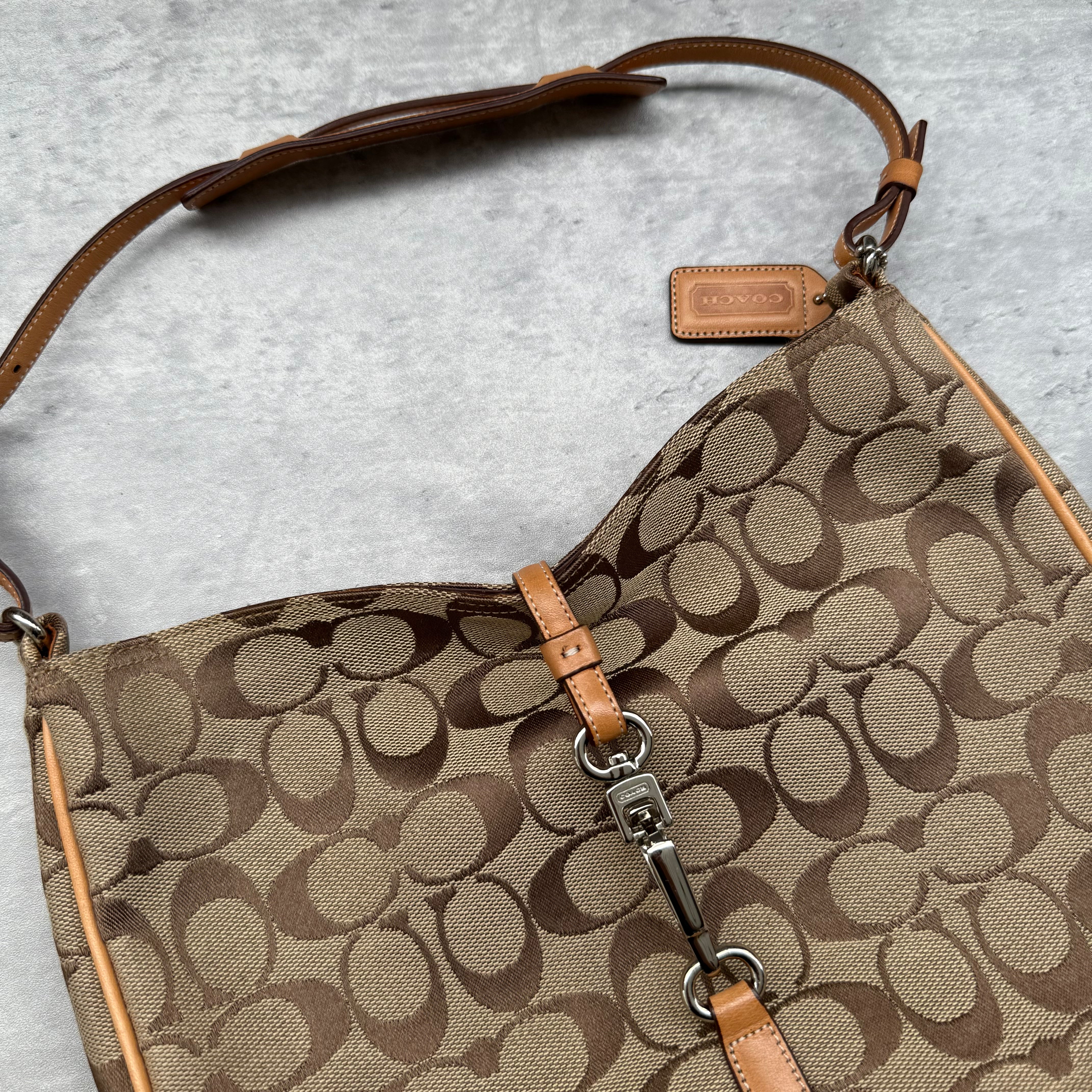 Coach Hobo Signature Clip Canvas Handbag Beige with monogram jacquard canvas, tan leather trim, front clip accent, and red-orange interior lining