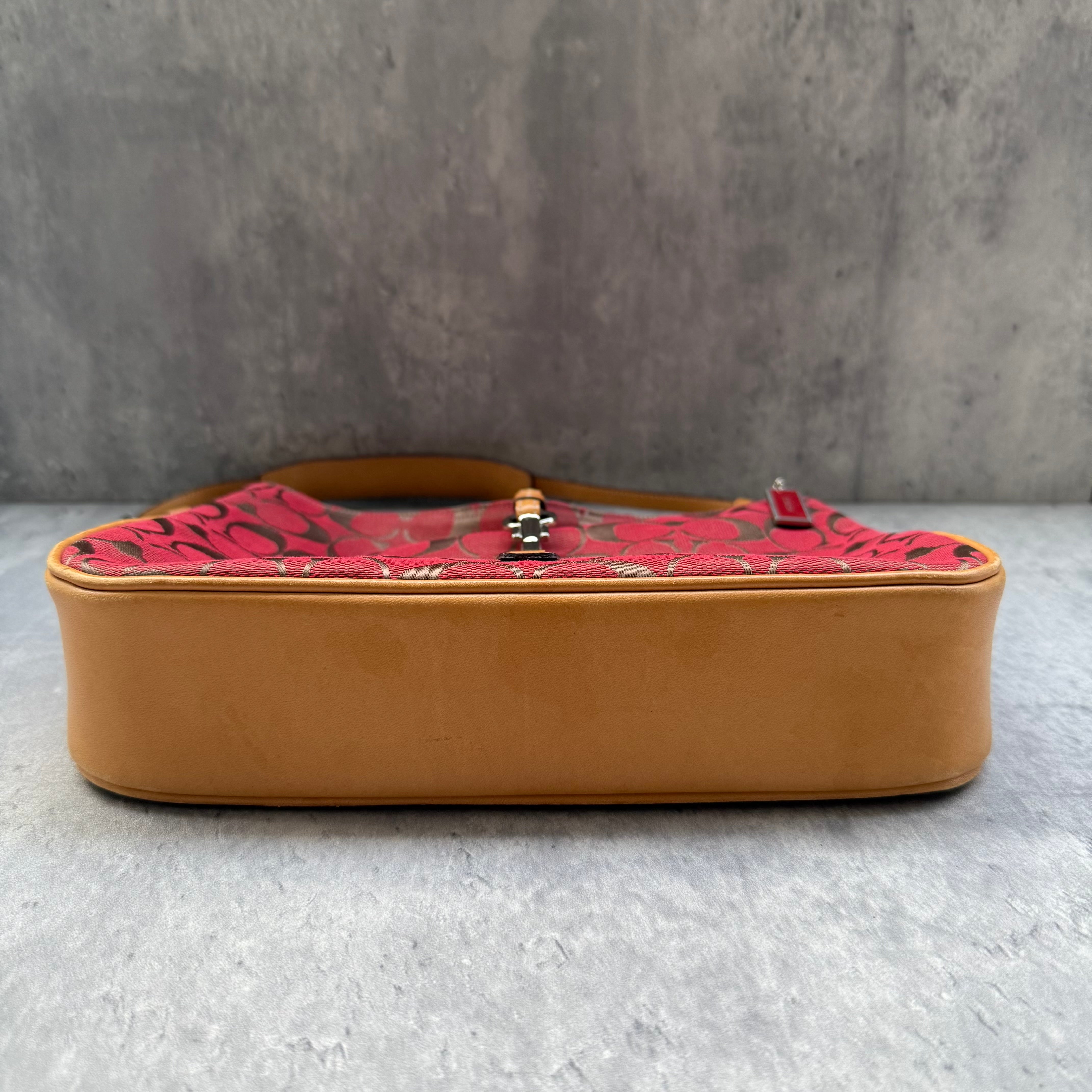 Coach Hobo Signature Clip Canvas Handbag in red monogram canvas with beige leather trim, front clip detail, and beige interior.