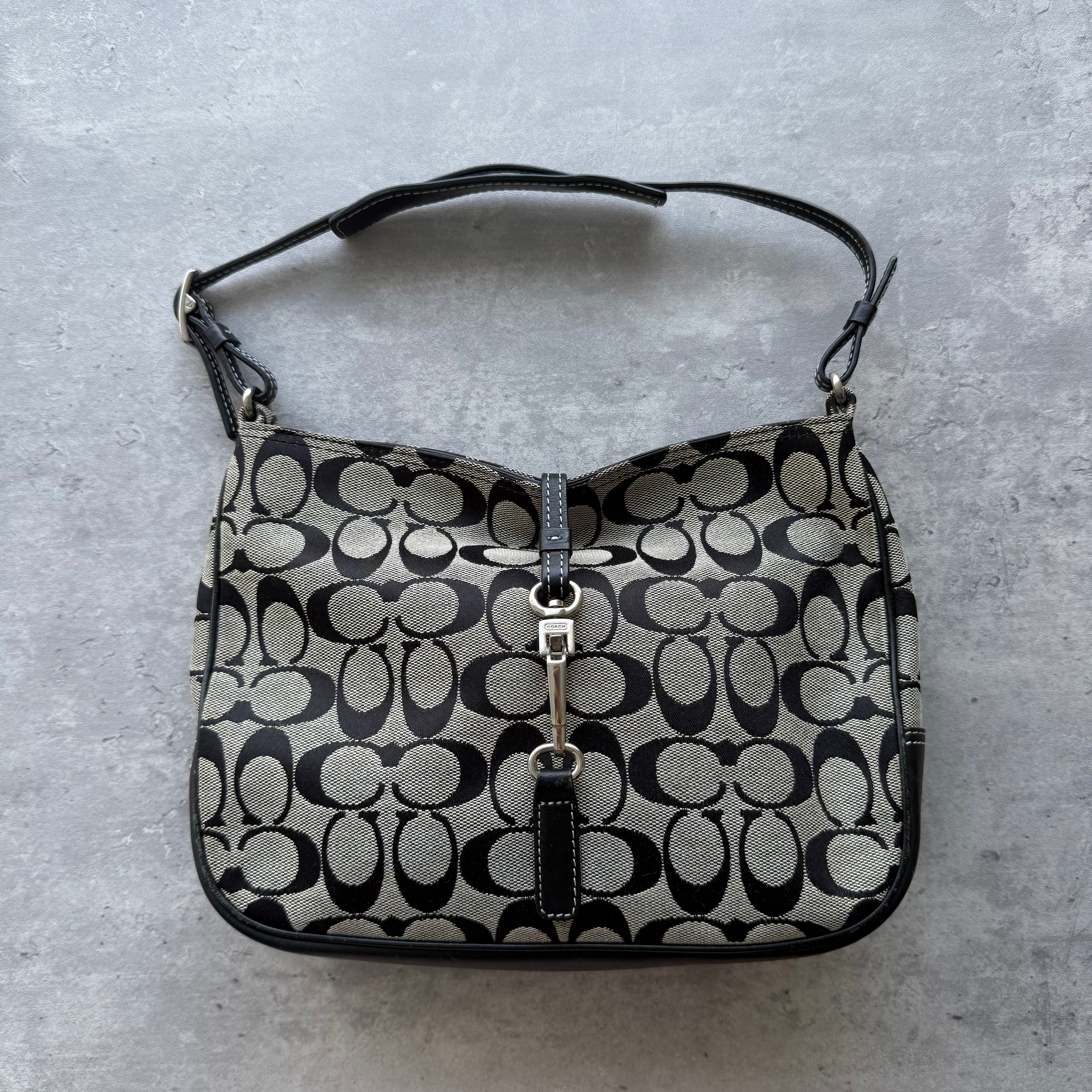 Coach Hobo Signature Clip Canvas Handbag in grey and black, featuring signature monogram jacquard, leather trim, and silver-tone clip closure.