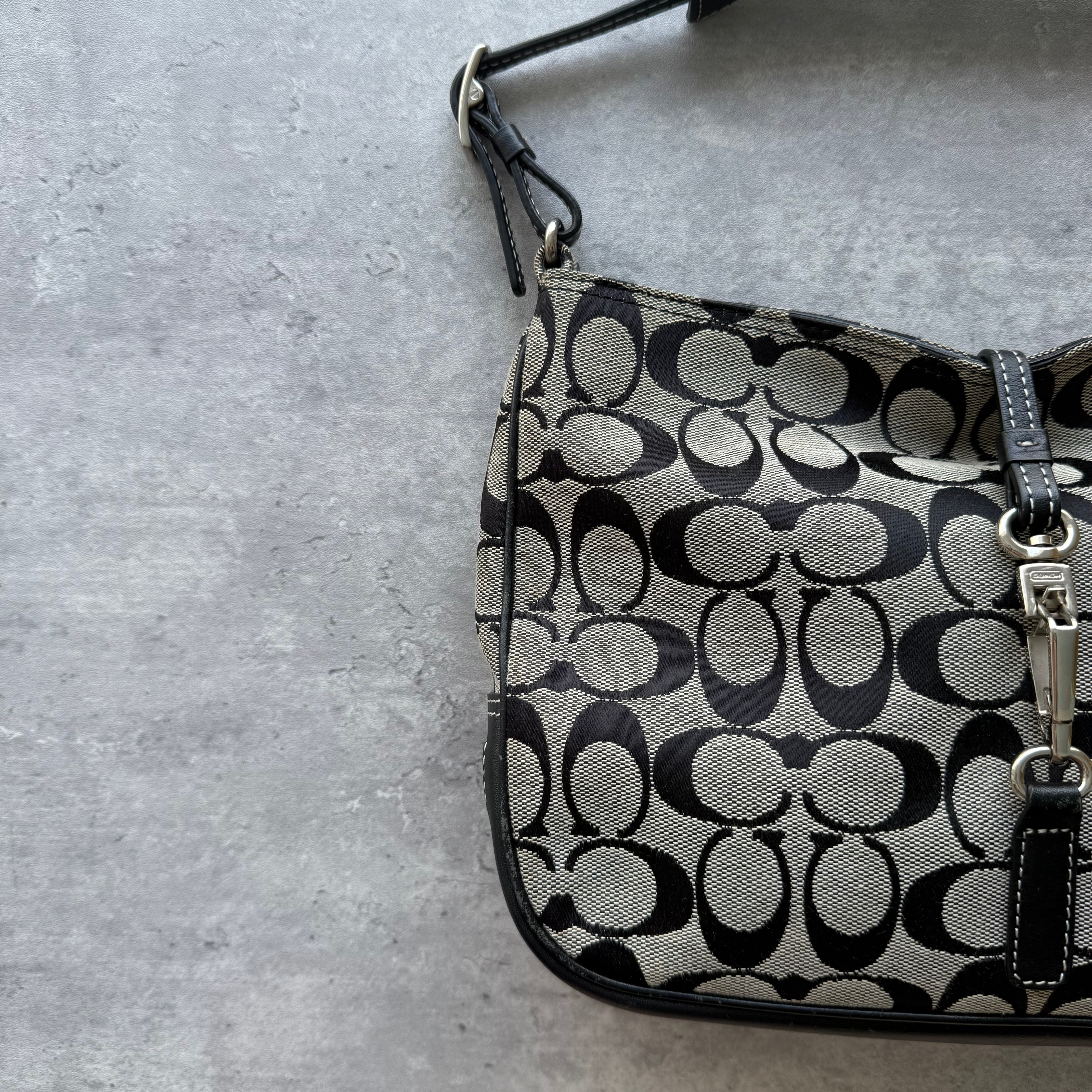 Coach Hobo Signature Clip Canvas Handbag in grey and black, featuring signature monogram jacquard, leather trim, and silver-tone clip closure.