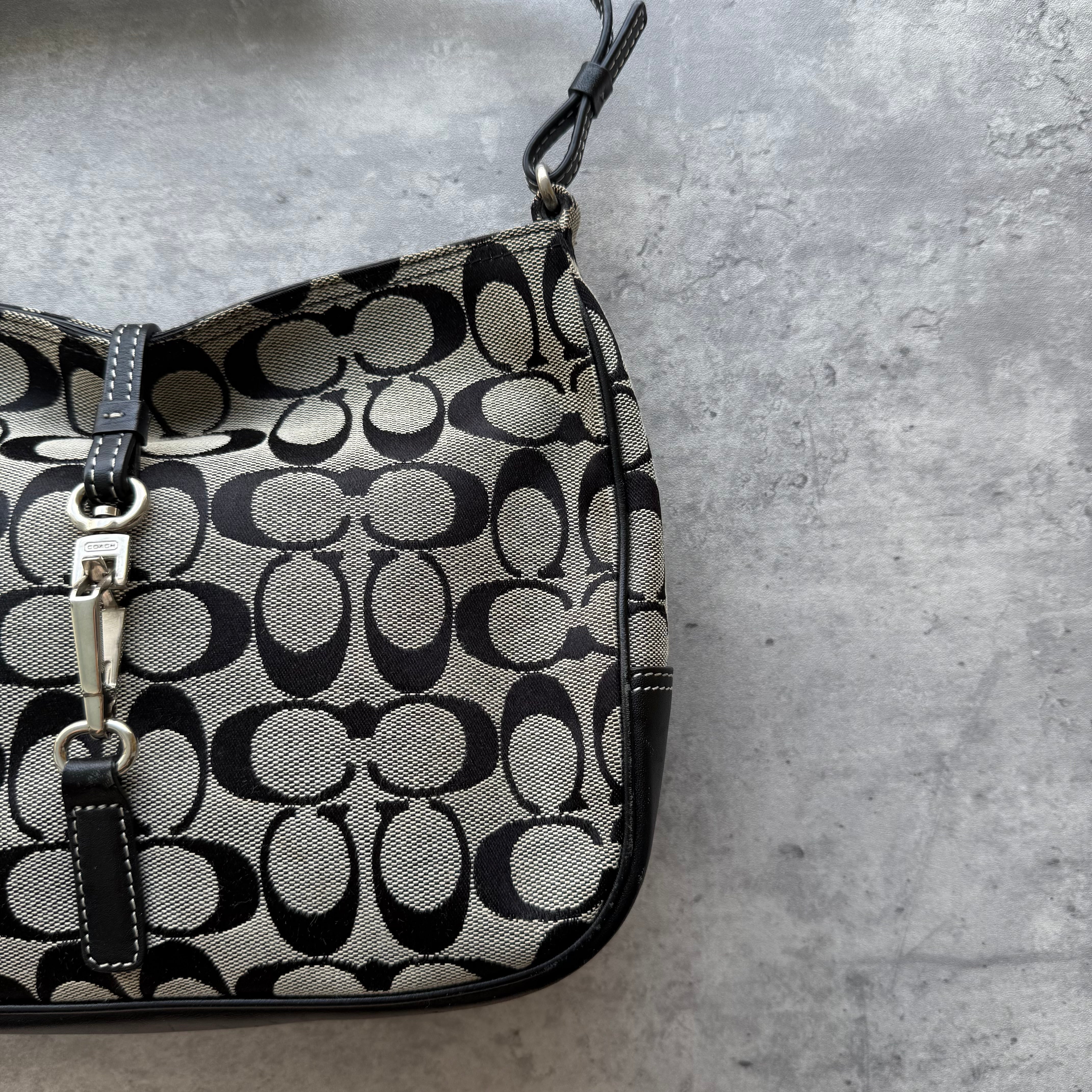 Coach Hobo Signature Clip Canvas Handbag in grey and black, featuring signature monogram jacquard, leather trim, and silver-tone clip closure.