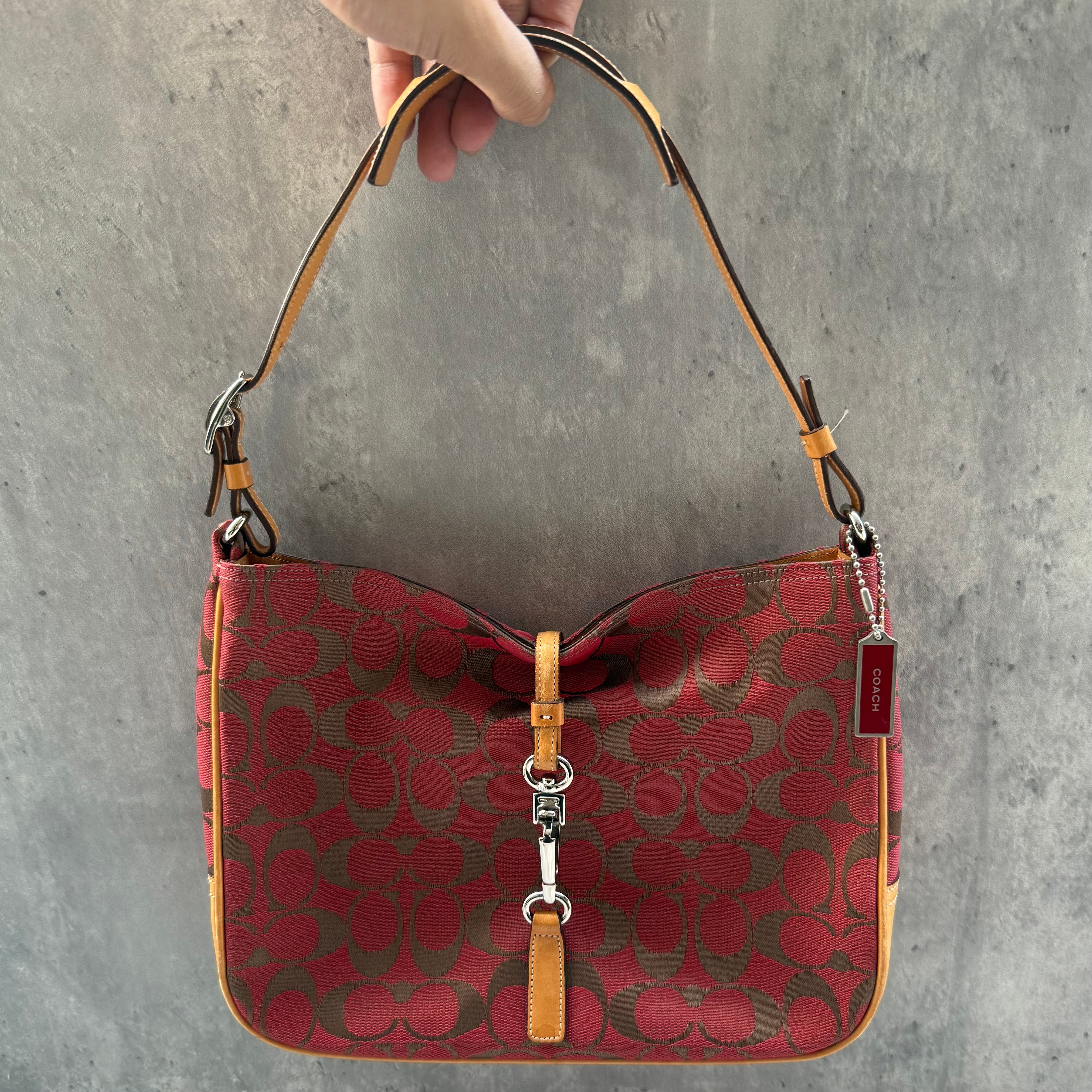 Coach Hobo Signature Clip Canvas Handbag in red monogram canvas with beige leather trim, front clip detail, and beige interior.