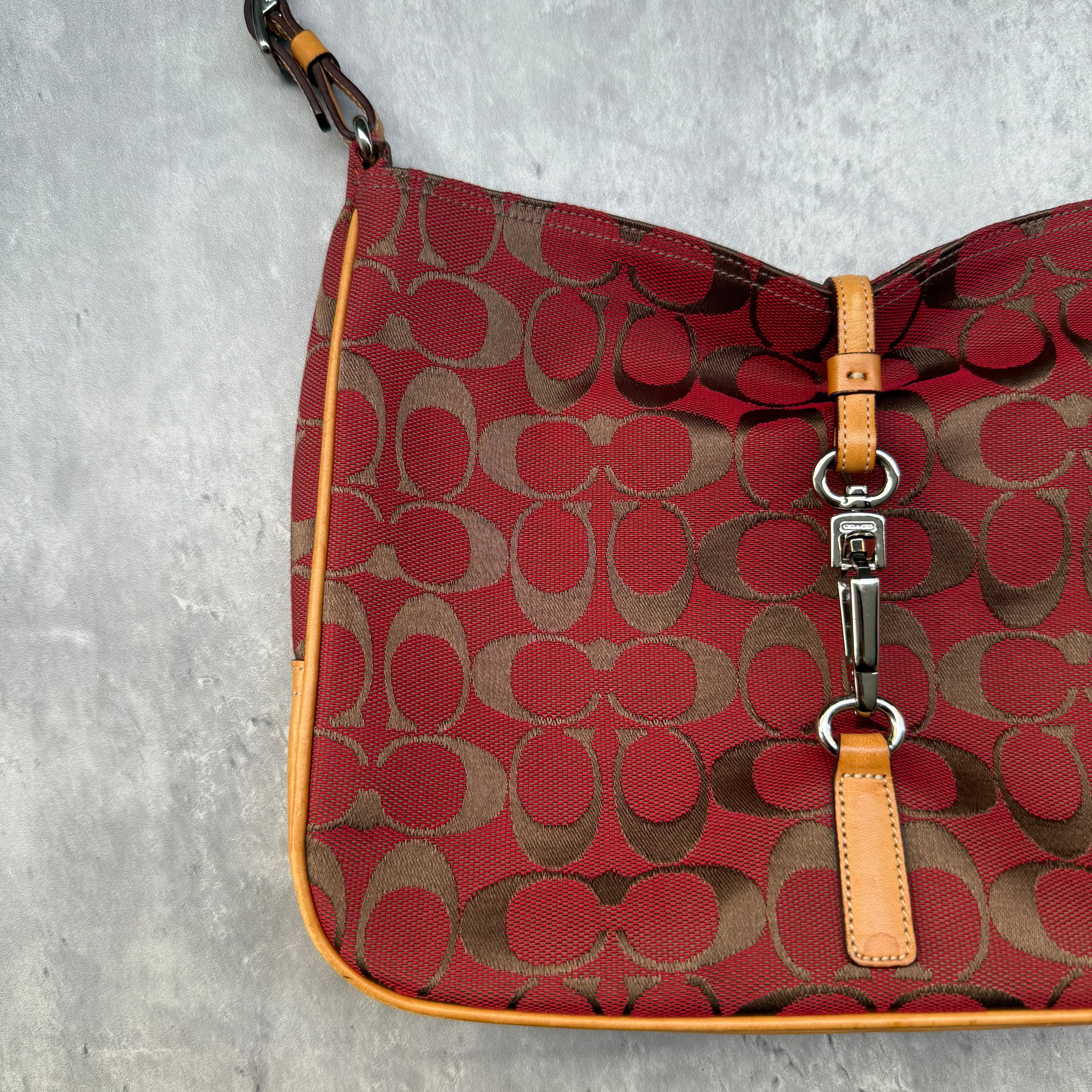 Coach Hobo Signature Clip Canvas Handbag in red monogram canvas with beige leather trim, front clip detail, and beige interior.