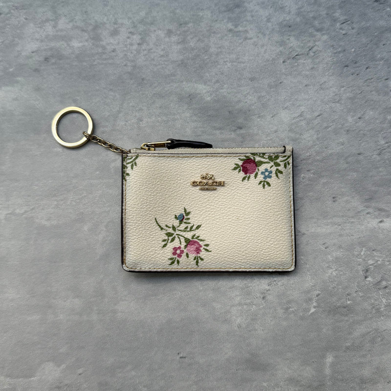 Coach Mini Skinny ID Antique Florant Print Key Cardholder in ivory pebble leather with pink floral print, zip-top closure, key ring chain, and clear ID window – Pre-loved
