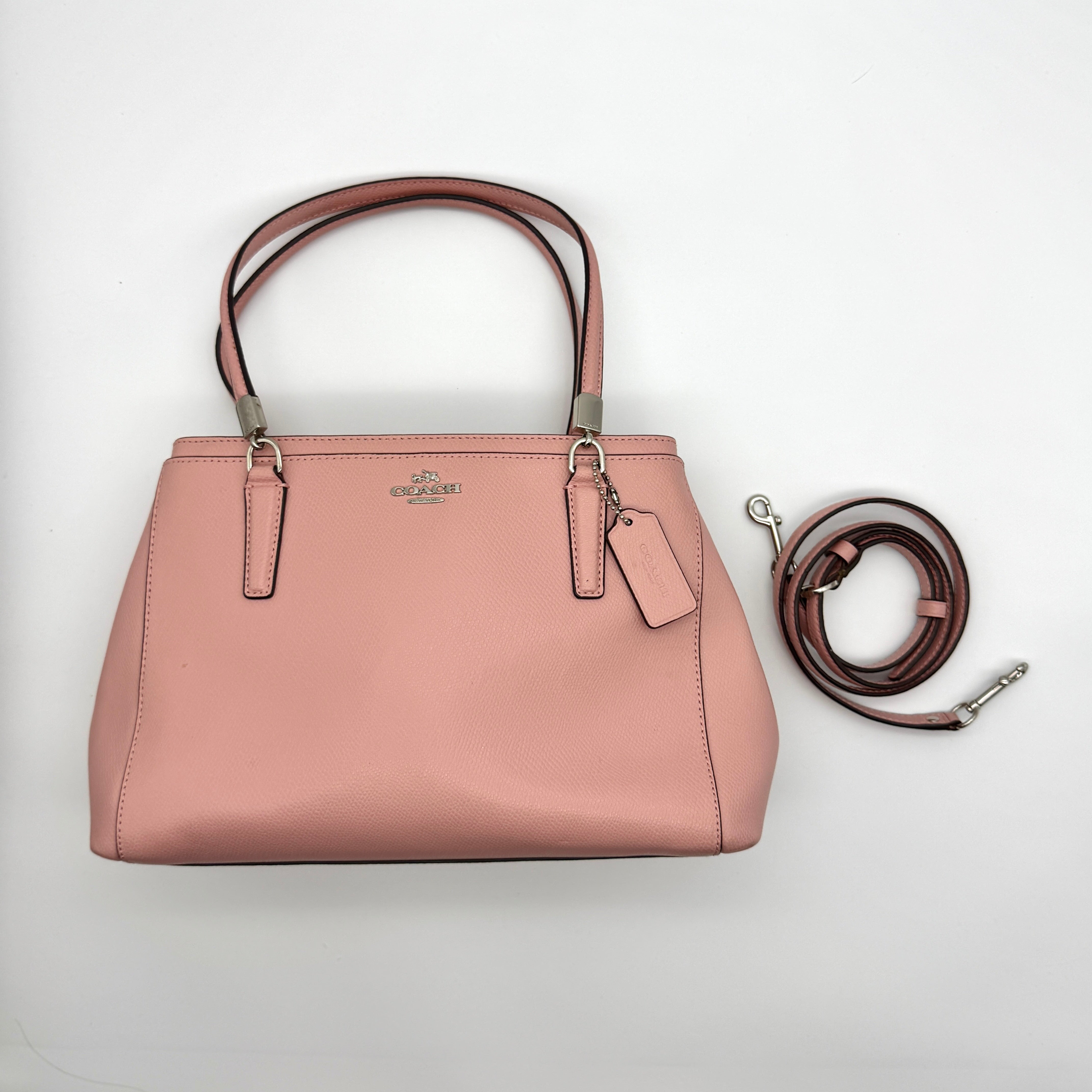 Coach Nolita 19 shoulder bag in pink crossgrain leather with double handles, detachable strap, and dual-zip compartments — pre-loved.