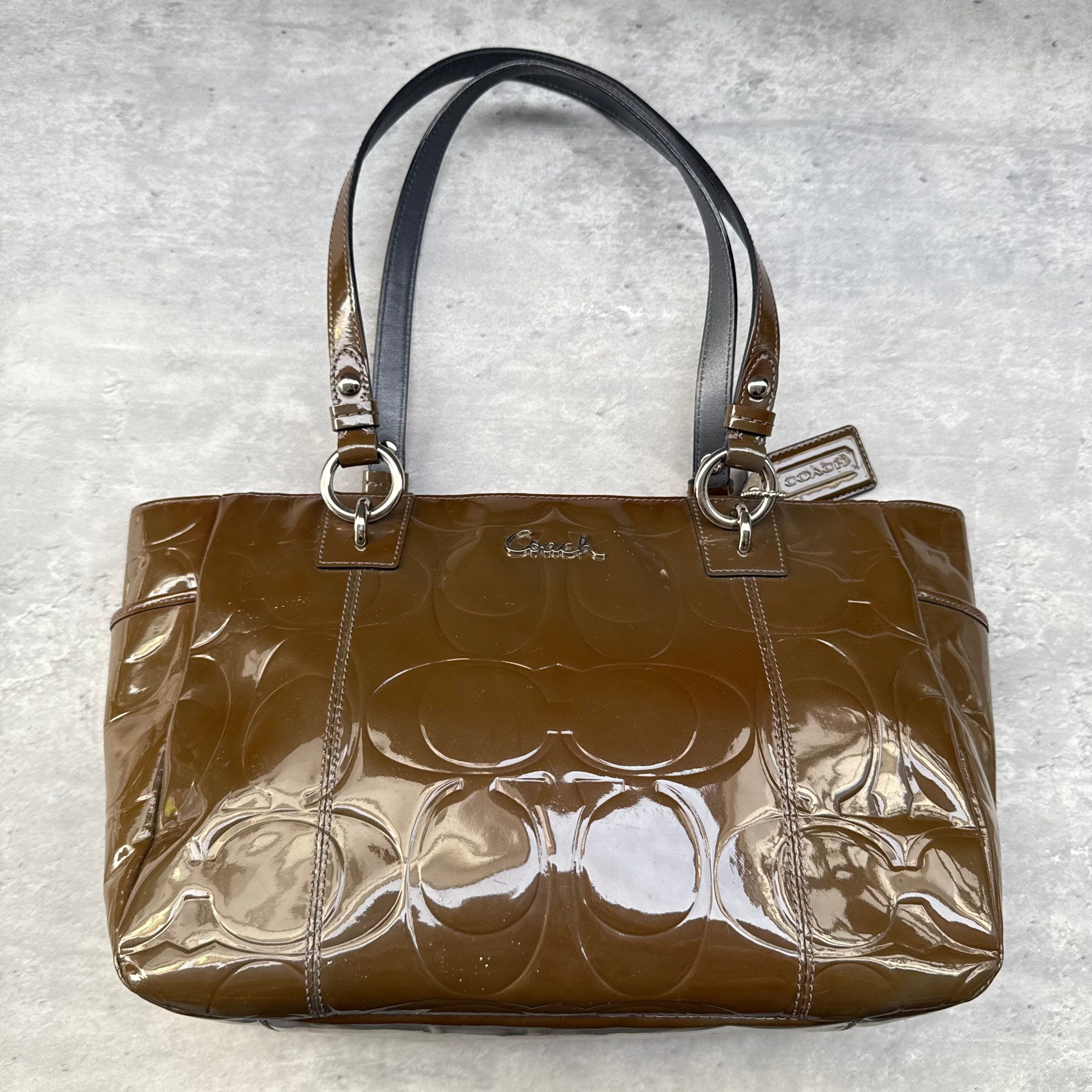 Coach Op Art Embossed Patent Leather Gallery Tote Bag in brown with glossy finish, embossed logo pattern, and lilac interior.