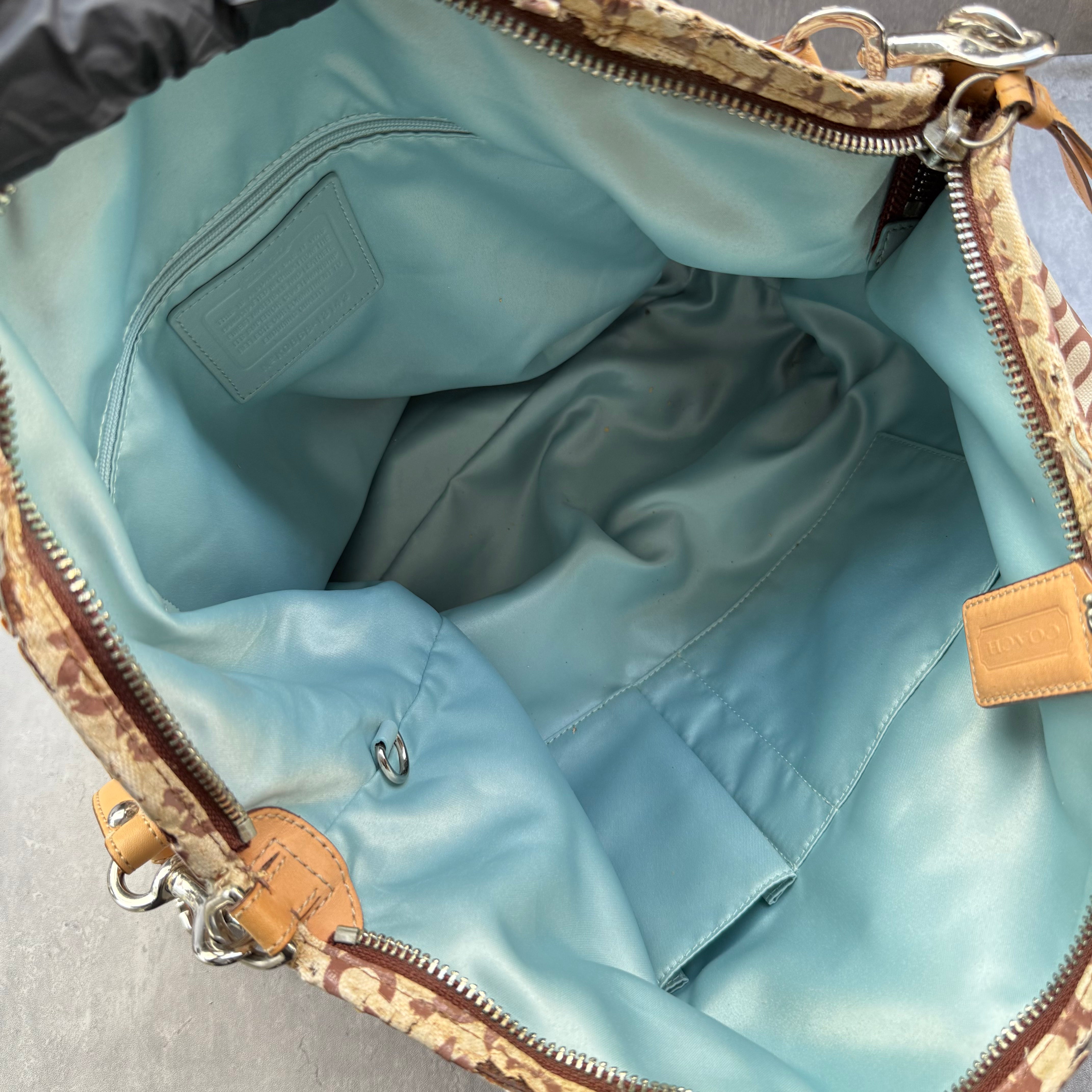 Coach Optic Art Coated Canvas Tote Bag with signature print, tan leather straps, sky blue lining, and front turn-lock pocket.