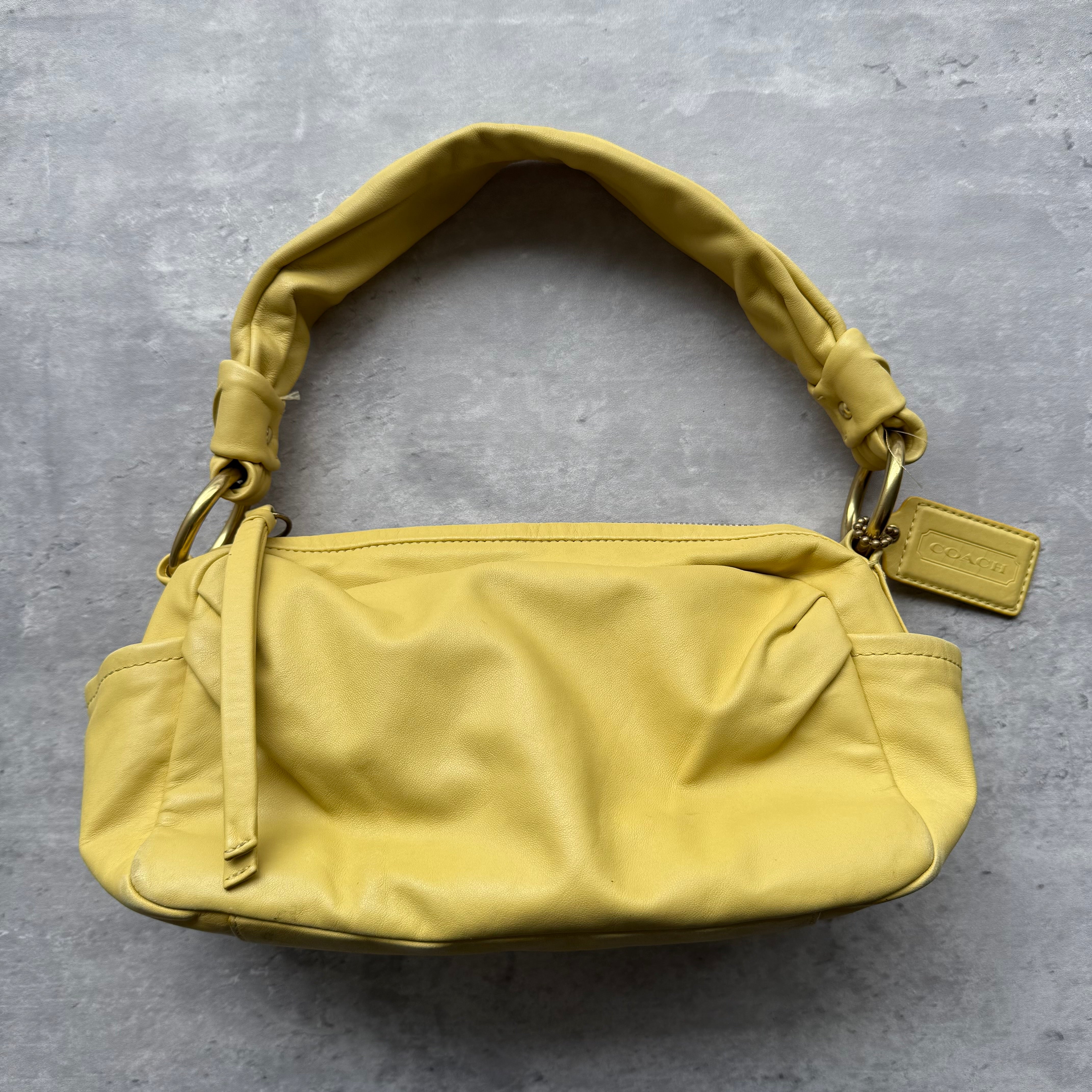 Coach Parker Hobo Shoulder Bag in smooth yellow leather with gold-tone hardware, knotted shoulder strap, and side slip pockets.
