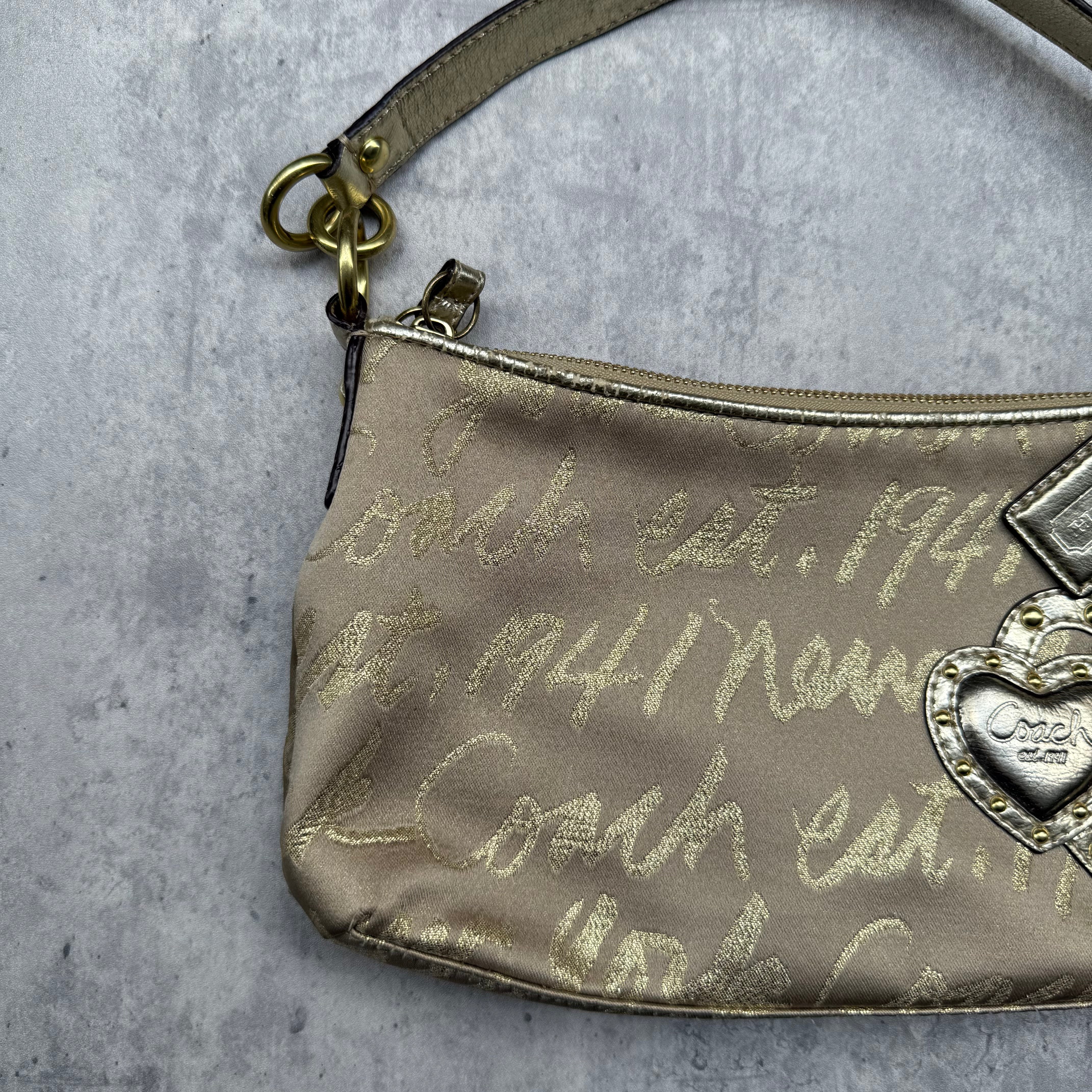 Coach Script Heart Shoulder Bag in beige satin with crystal heart charm, lavender interior, and gold-tone hardware.