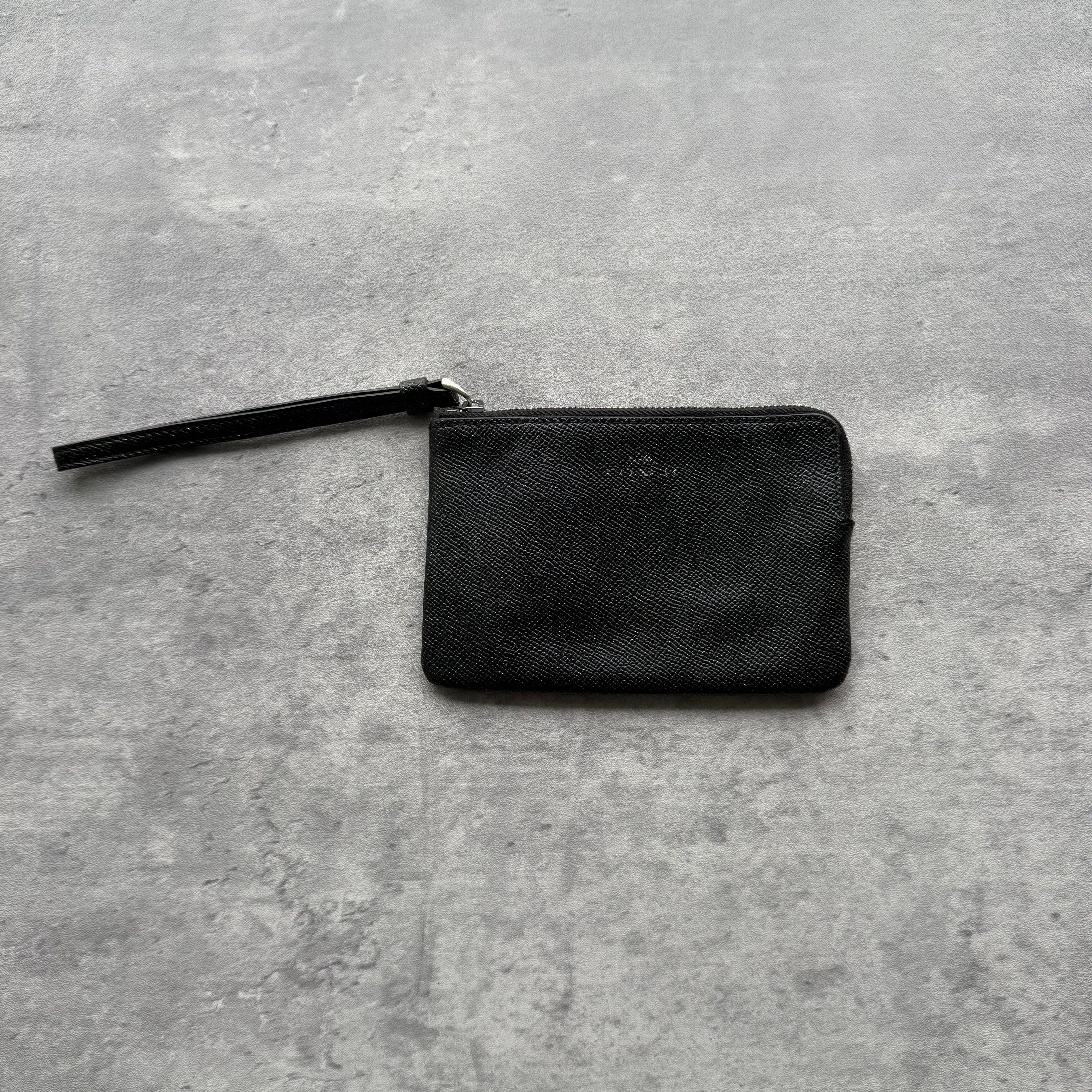Coach Signature Black Wristlet in textured leather with detachable strap and zip closure.