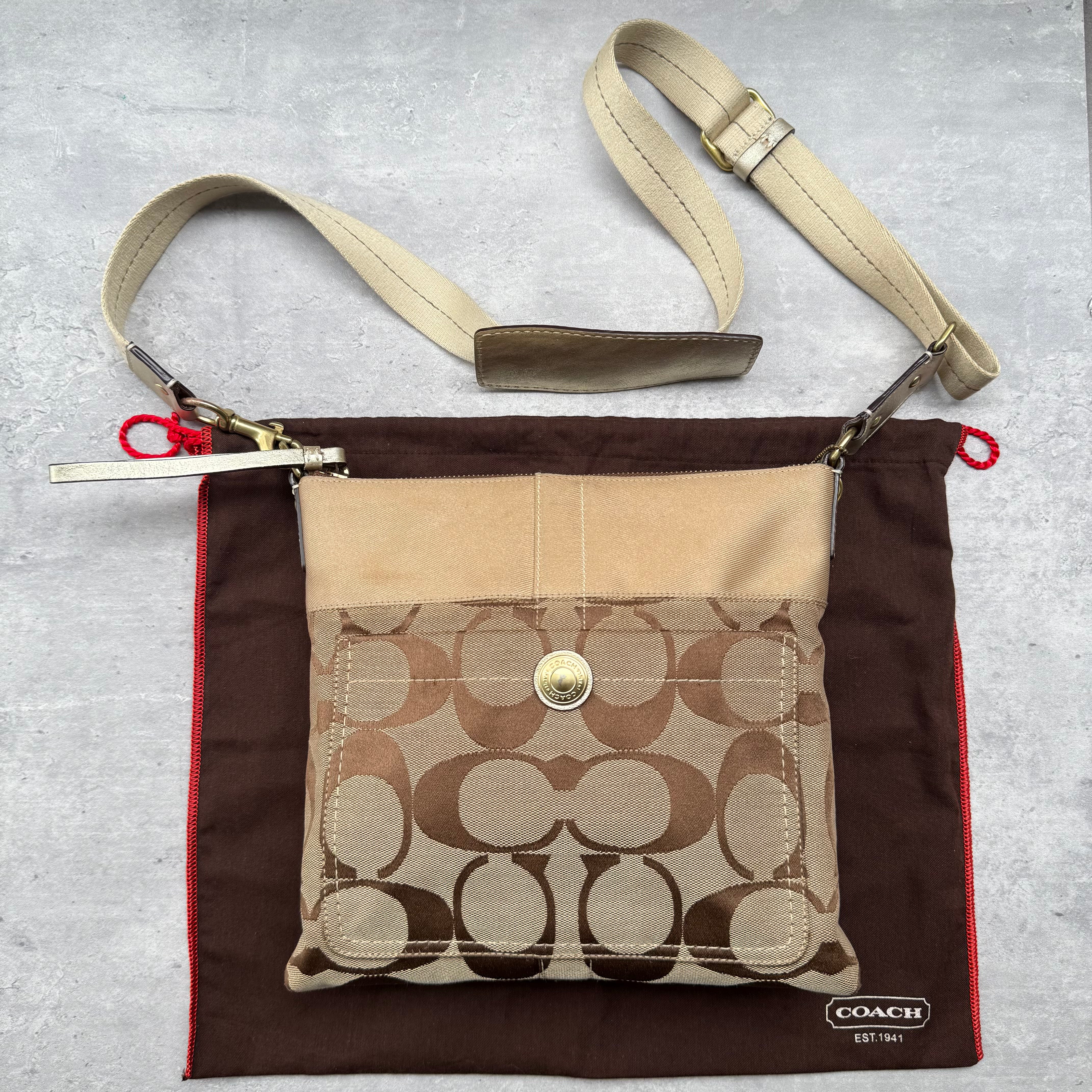 Coach Signature Canvas Crossbody Bag in beige with brown leather trim, front snap pocket, and adjustable strap.