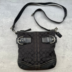 Coach Signature Canvas Crossbody Bag Black with silver-tone buckle accents and leather trim, featuring zip-top closure and adjustable strap.