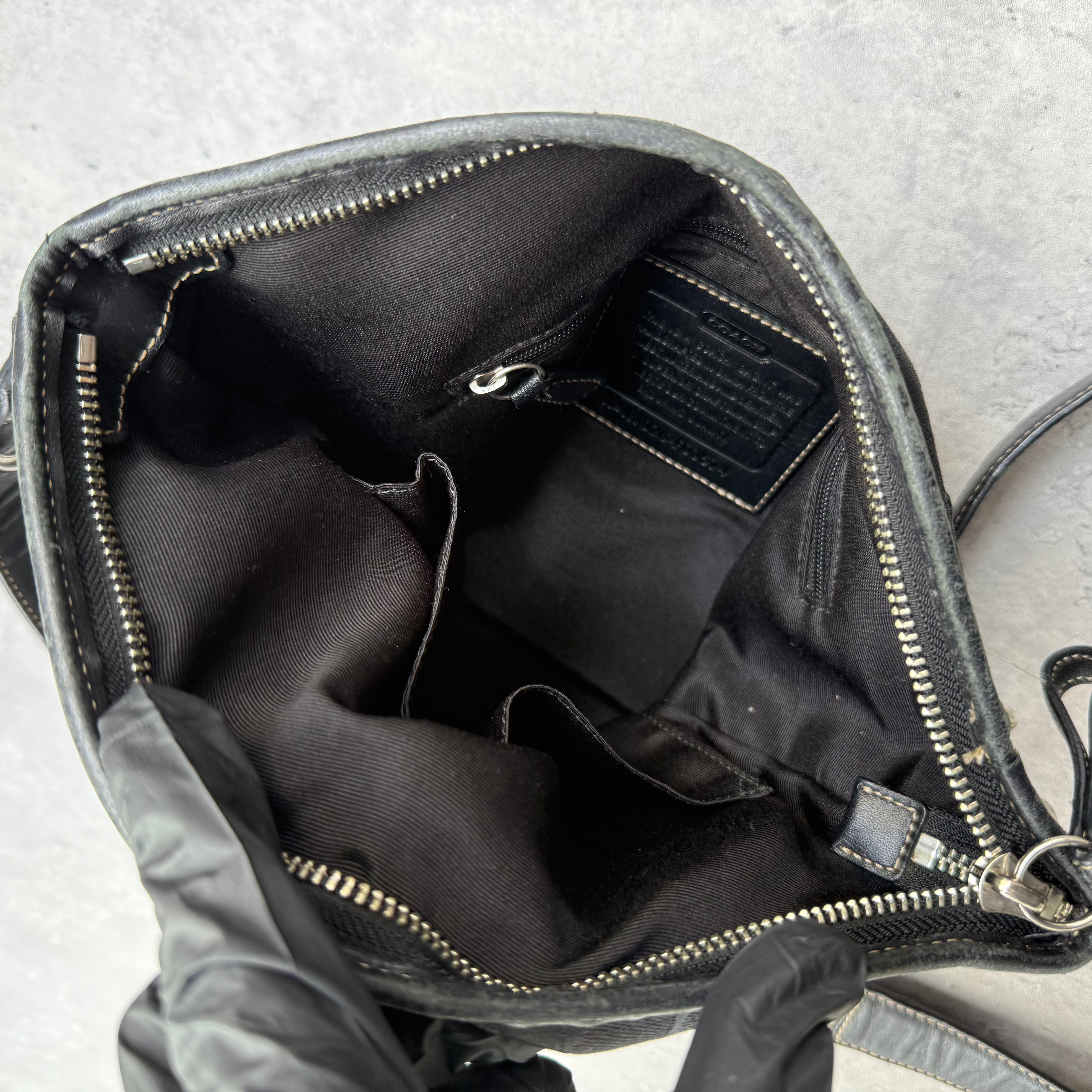 Coach Signature Canvas Crossbody Bag Black with leather trim, dual buckle detail, and silver-tone hardware