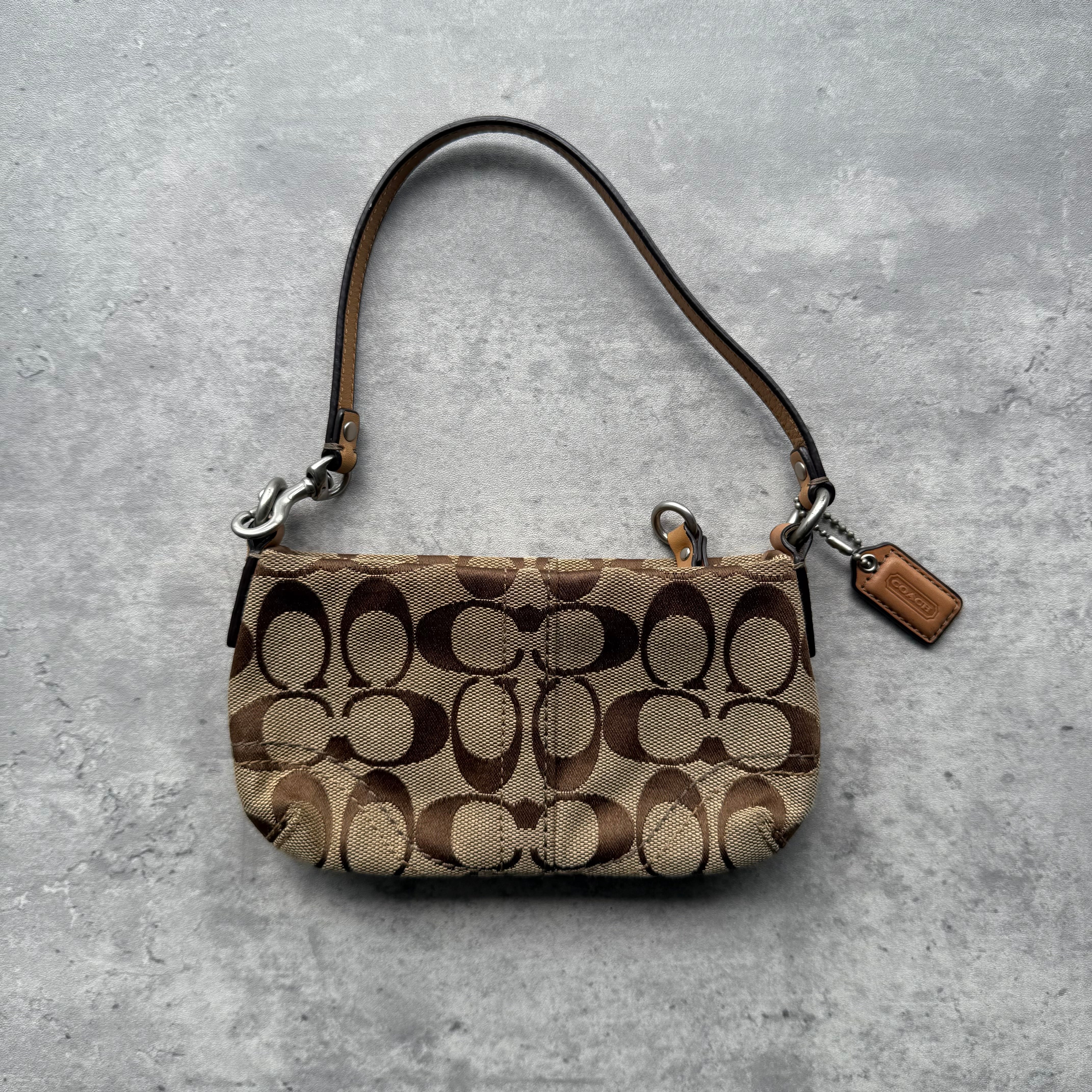 Coach Signature Canvas Mini Bag in beige with brown leather trim and silver-tone hardware.