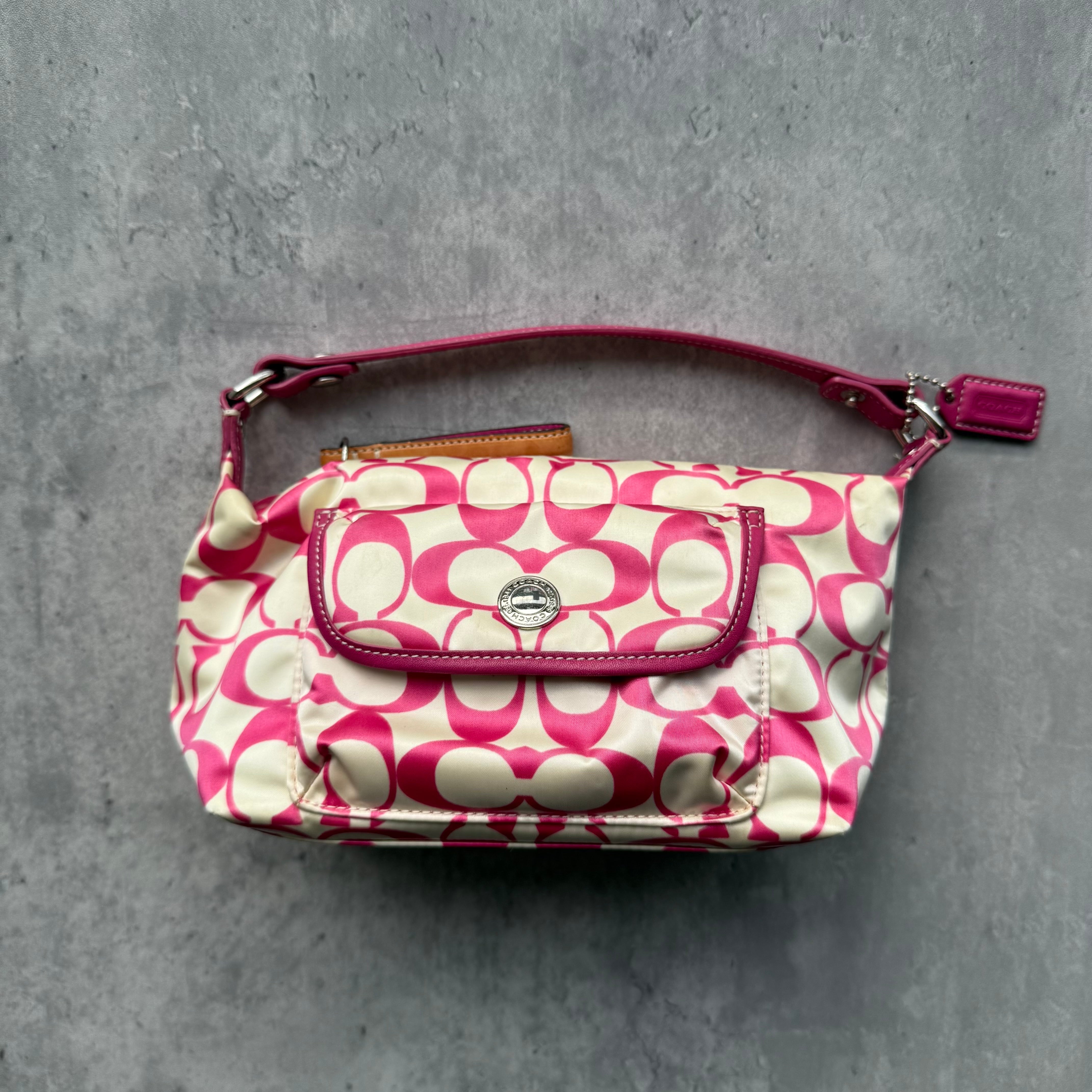 Coach Signature Canvas Mini Shoulder Bag in pink and white with front flap pocket and silver-tone hardware.