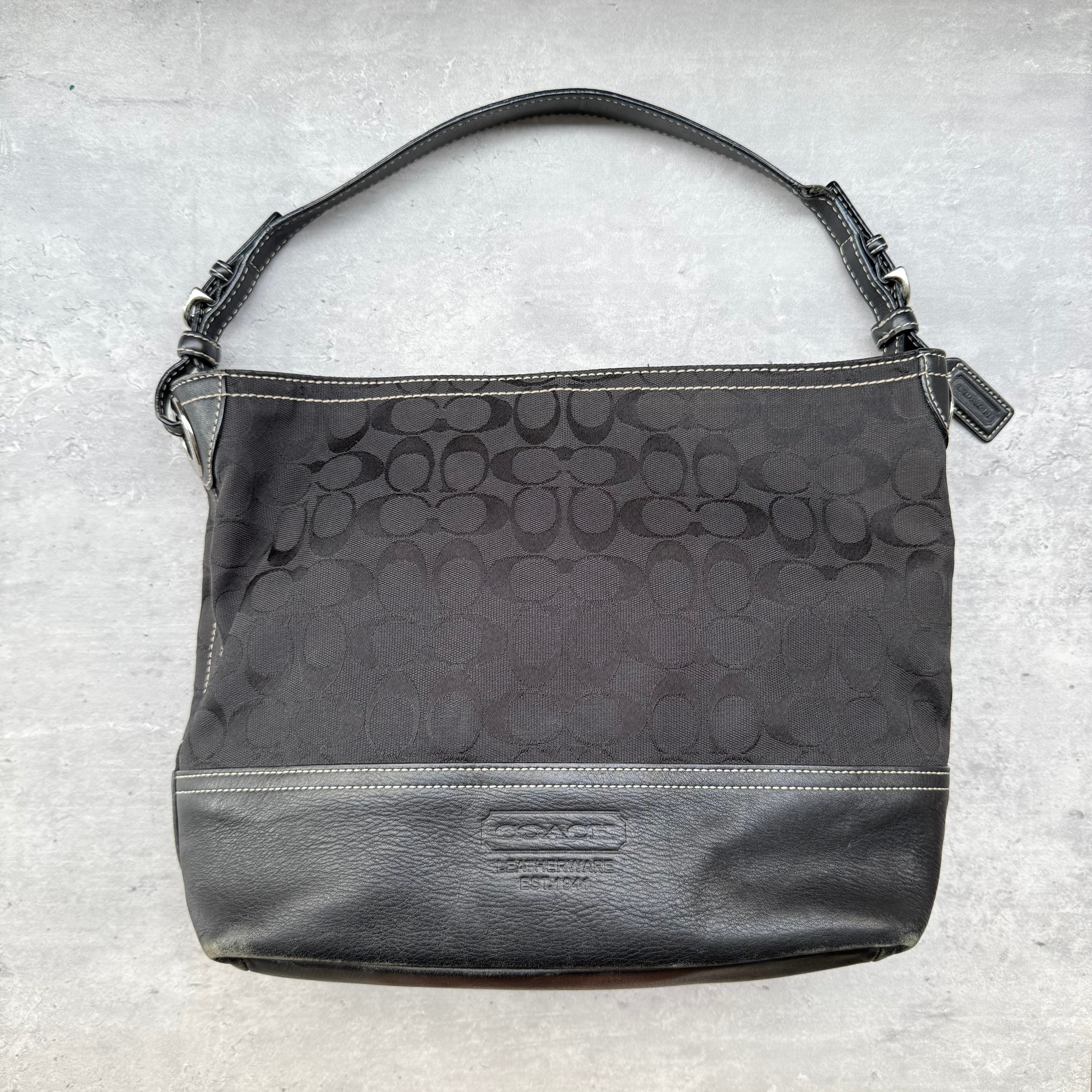 Coach Signature Canvas Shoulder Bag Black with leather trim, single shoulder strap, and spacious interior