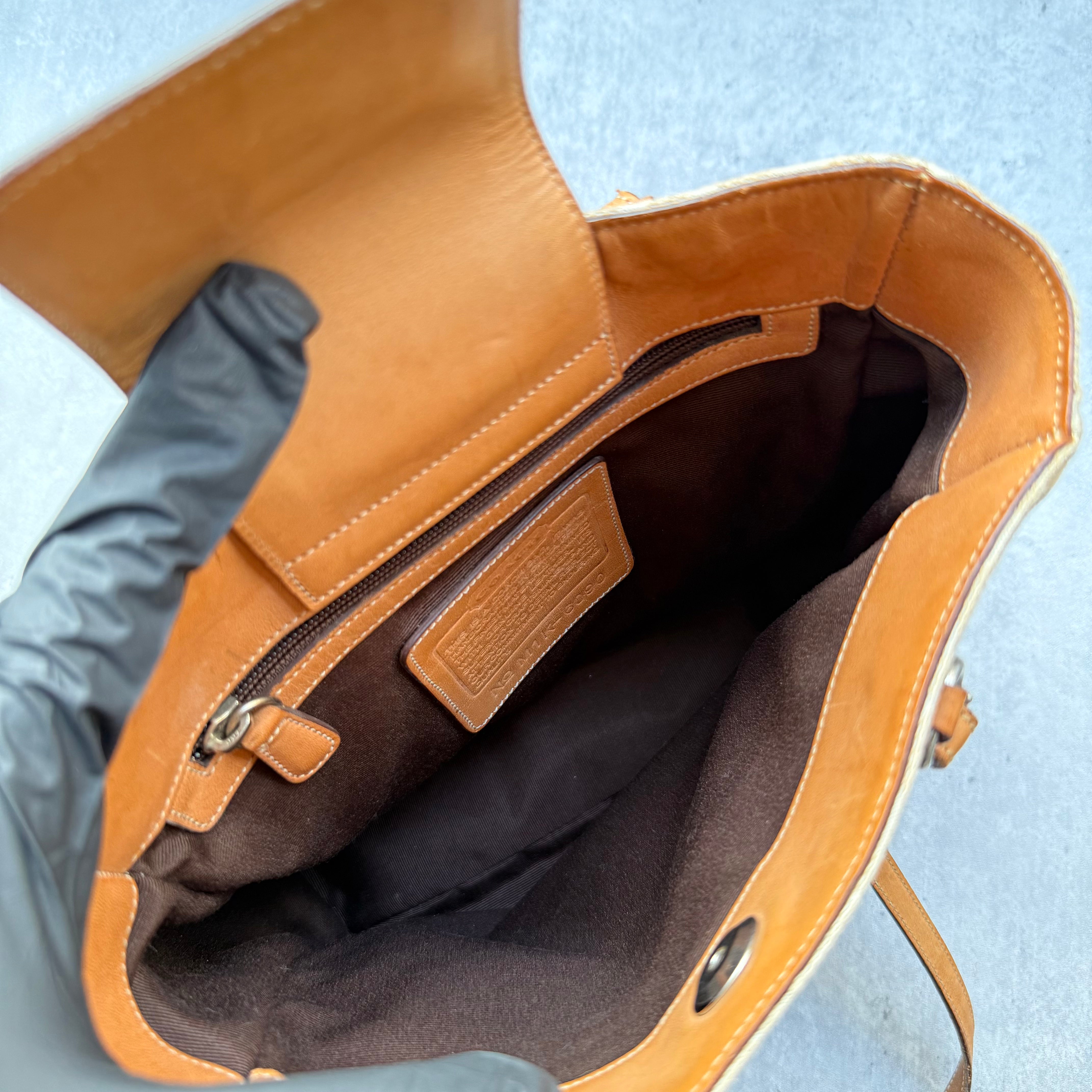 Coach Signature Canvas Tote Bag in beige with monogram pattern, tan leather trim, and shoulder straps