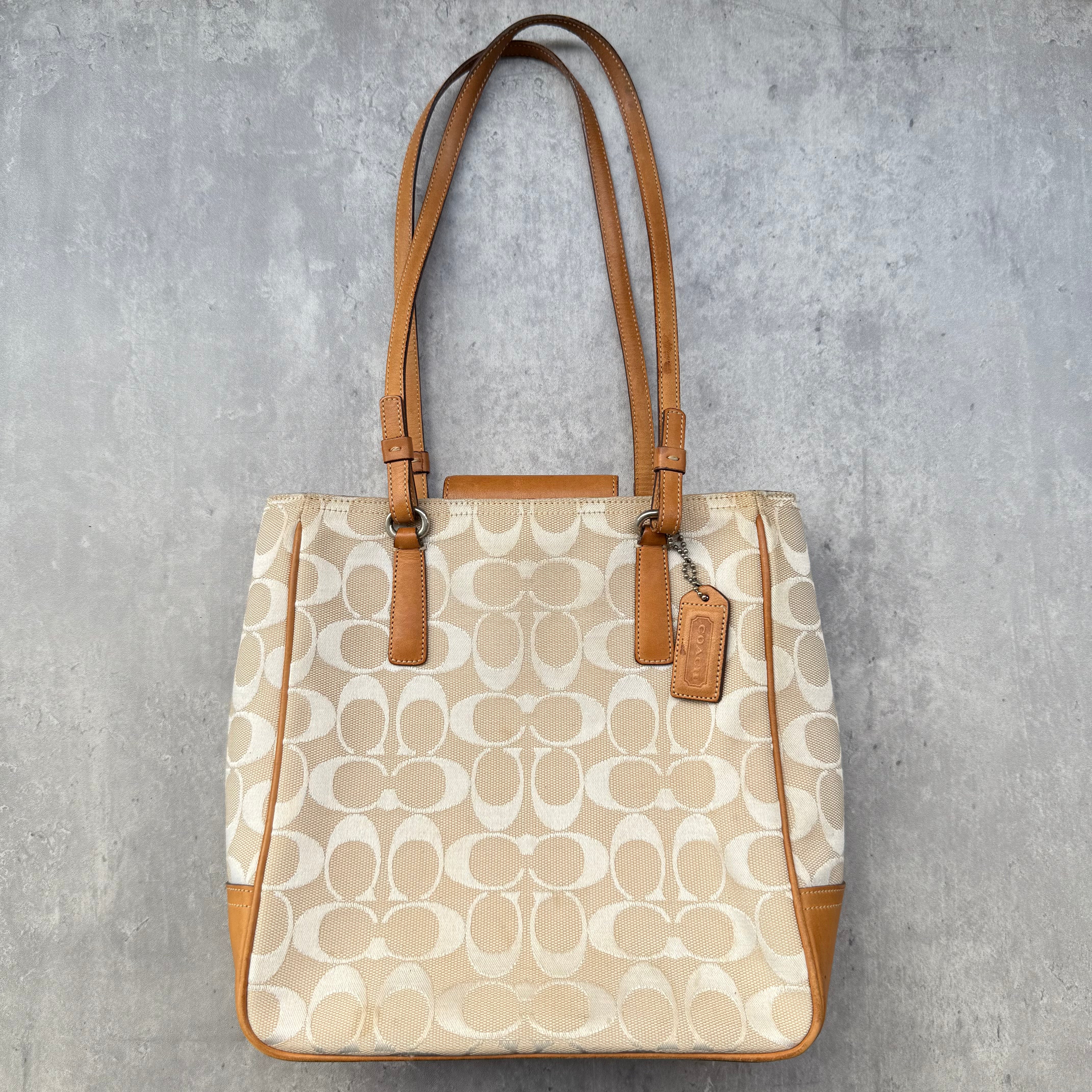 Coach Signature Canvas Tote Bag in beige with monogram pattern, tan leather trim, and shoulder straps