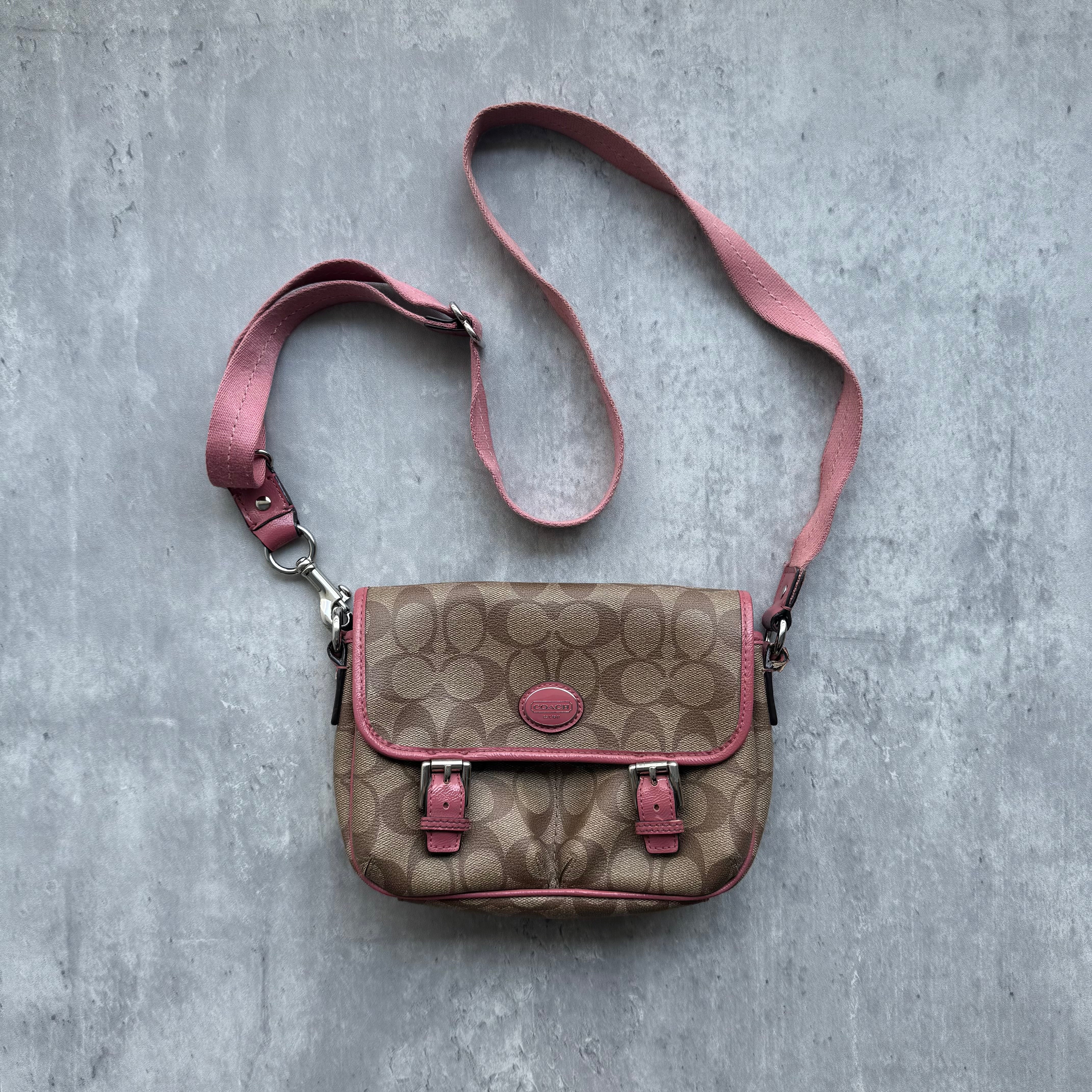 Coach Signature Crossbody Bag in beige monogram canvas with pink leather trim, adjustable pink strap, and front flap buckle design.
