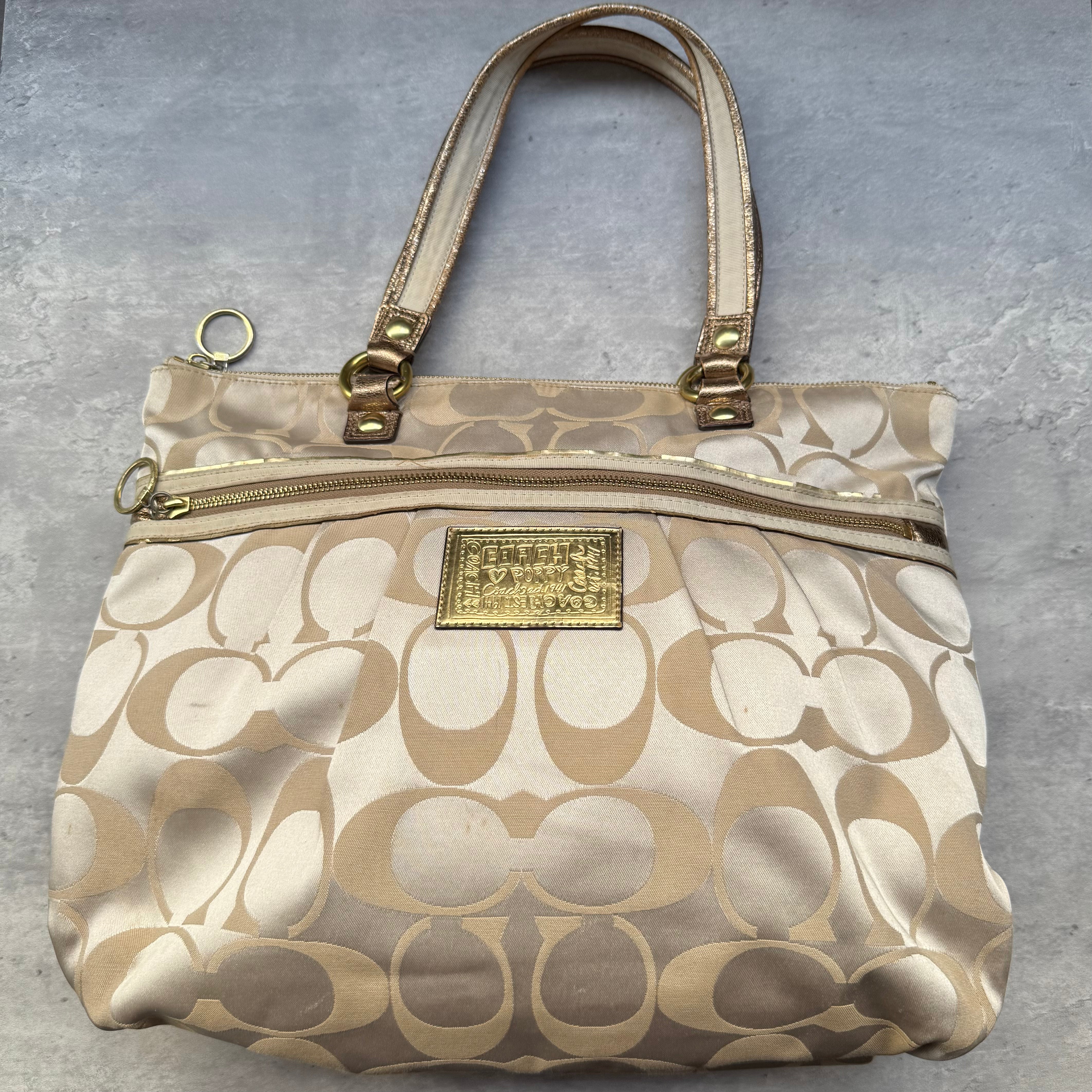 Coach Signature Daisy Poppy Tote Bag in gold and beige jacquard with metallic leather trim and turquoise lining.
