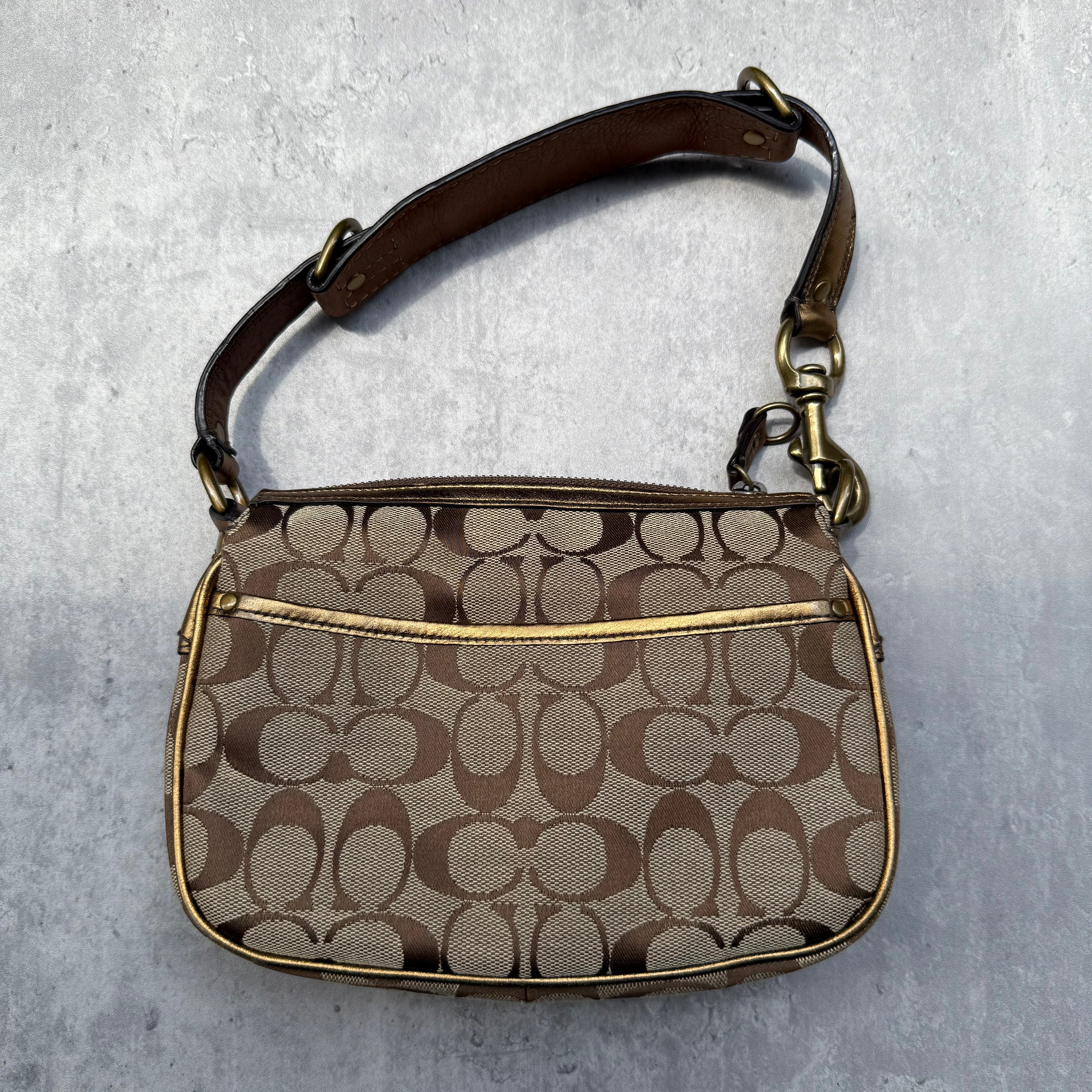 Coach Signature Shoulder Bag in beige canvas with gold metallic front buckle pocket, brown suede accents, and short strap.