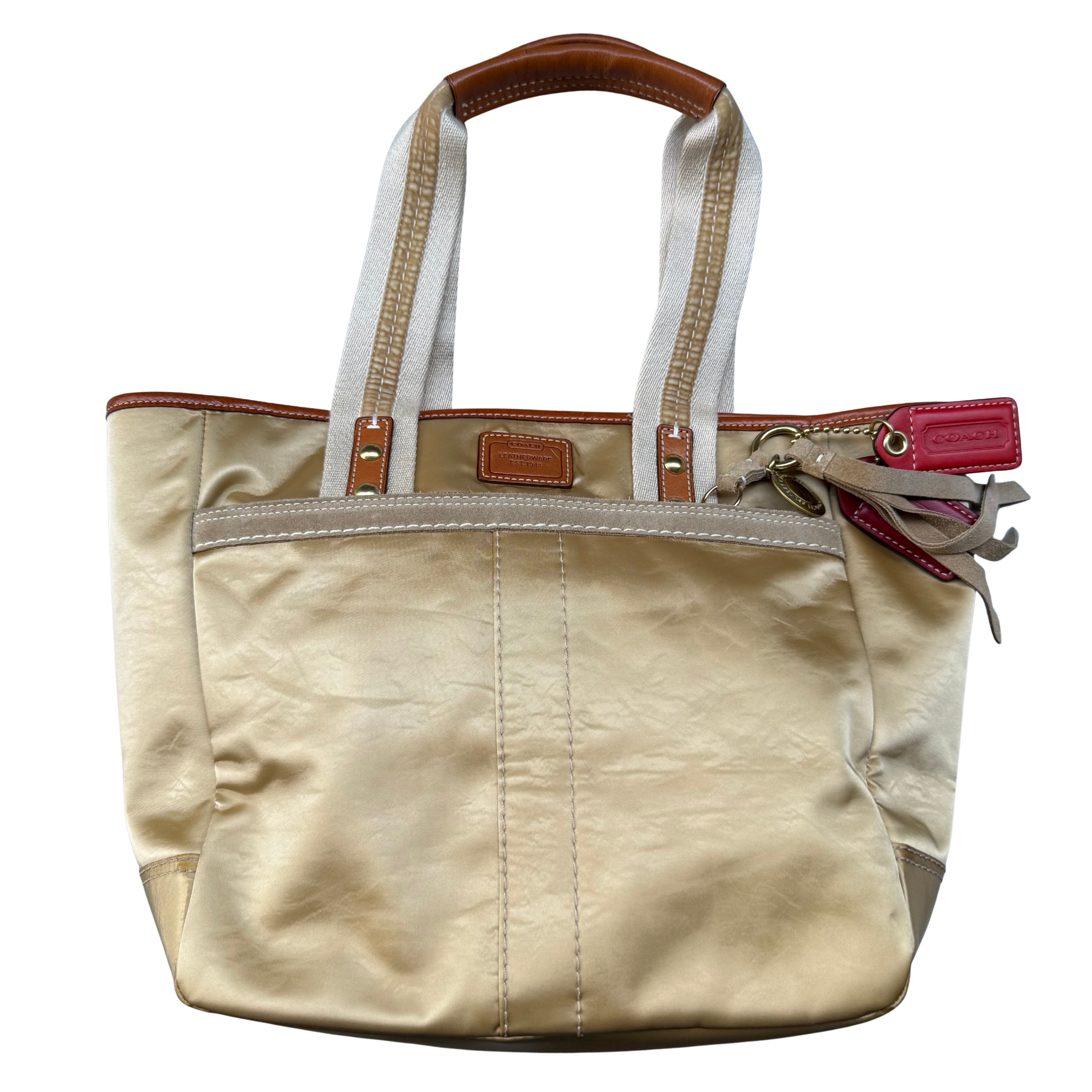 Coach Signature Hampton Tote Bag in gold fabric with leather trim and signature jacquard interior lining.