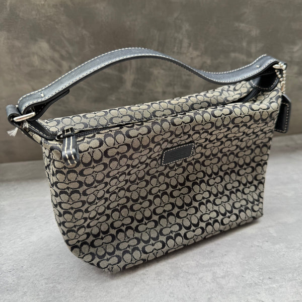 Coach Signature Mini Hobo Shoulder Bag in grey and black canvas with monogram print and black leather trim.


