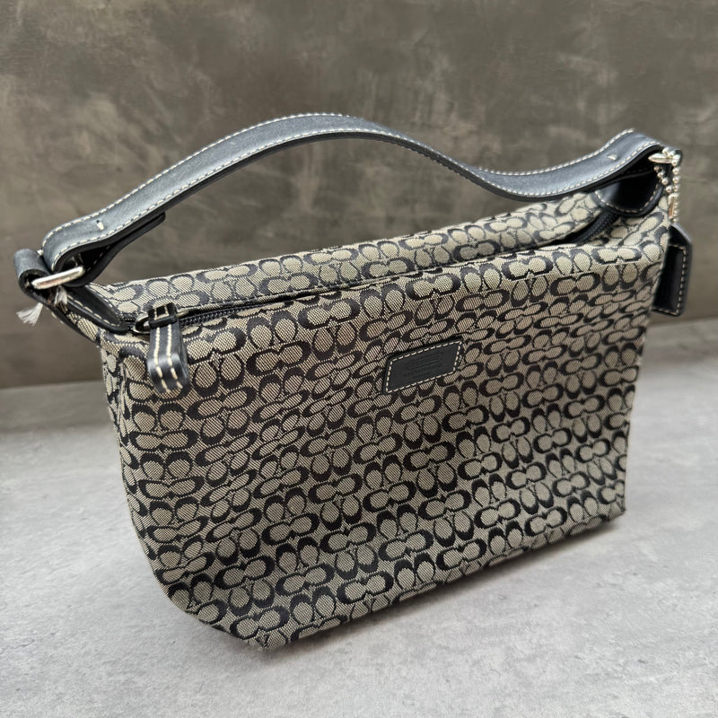 Coach Signature Mini Hobo Shoulder Bag in grey and black canvas with monogram print and black leather trim.

