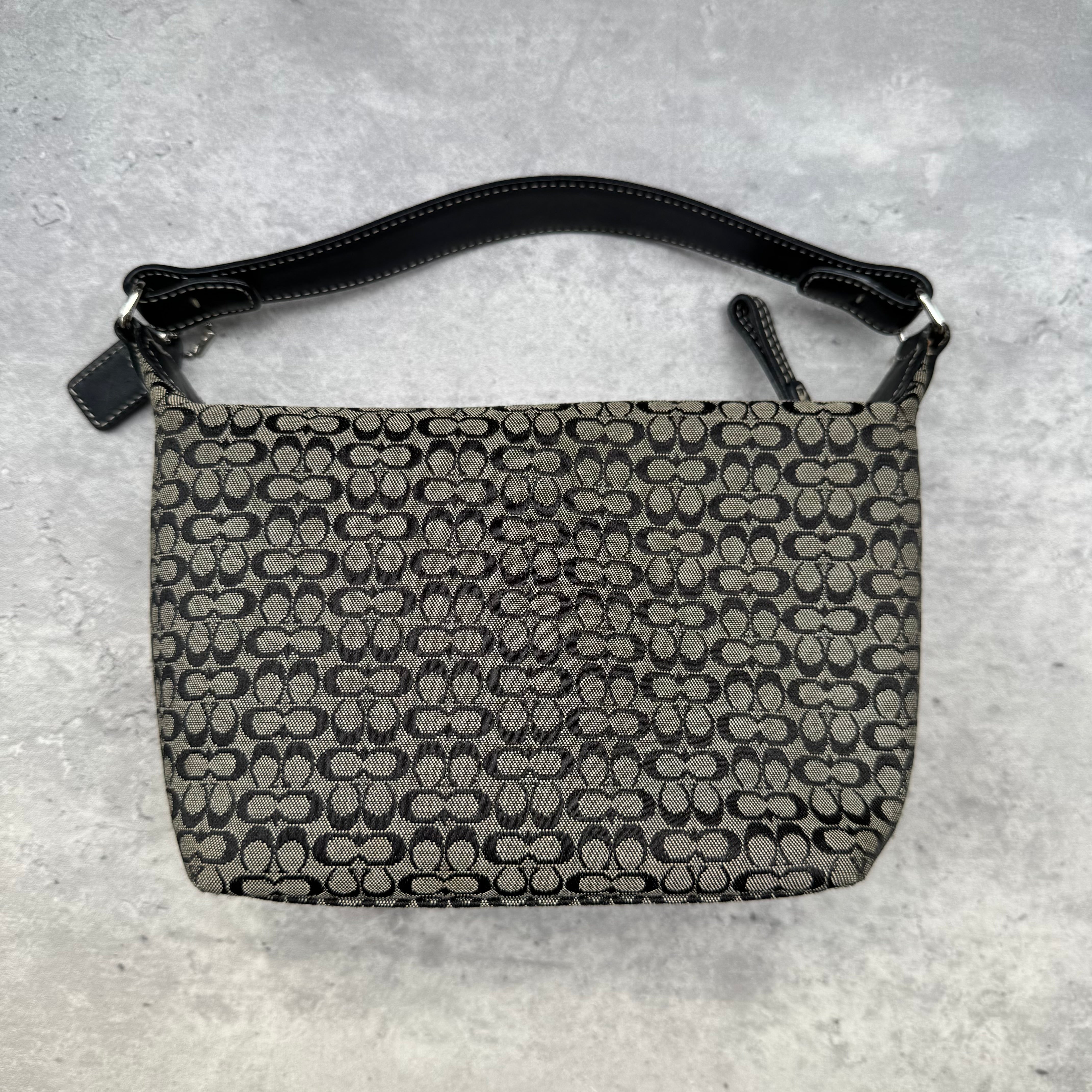 Coach Signature Mini Hobo Shoulder Bag in grey and black canvas with monogram print and black leather trim.