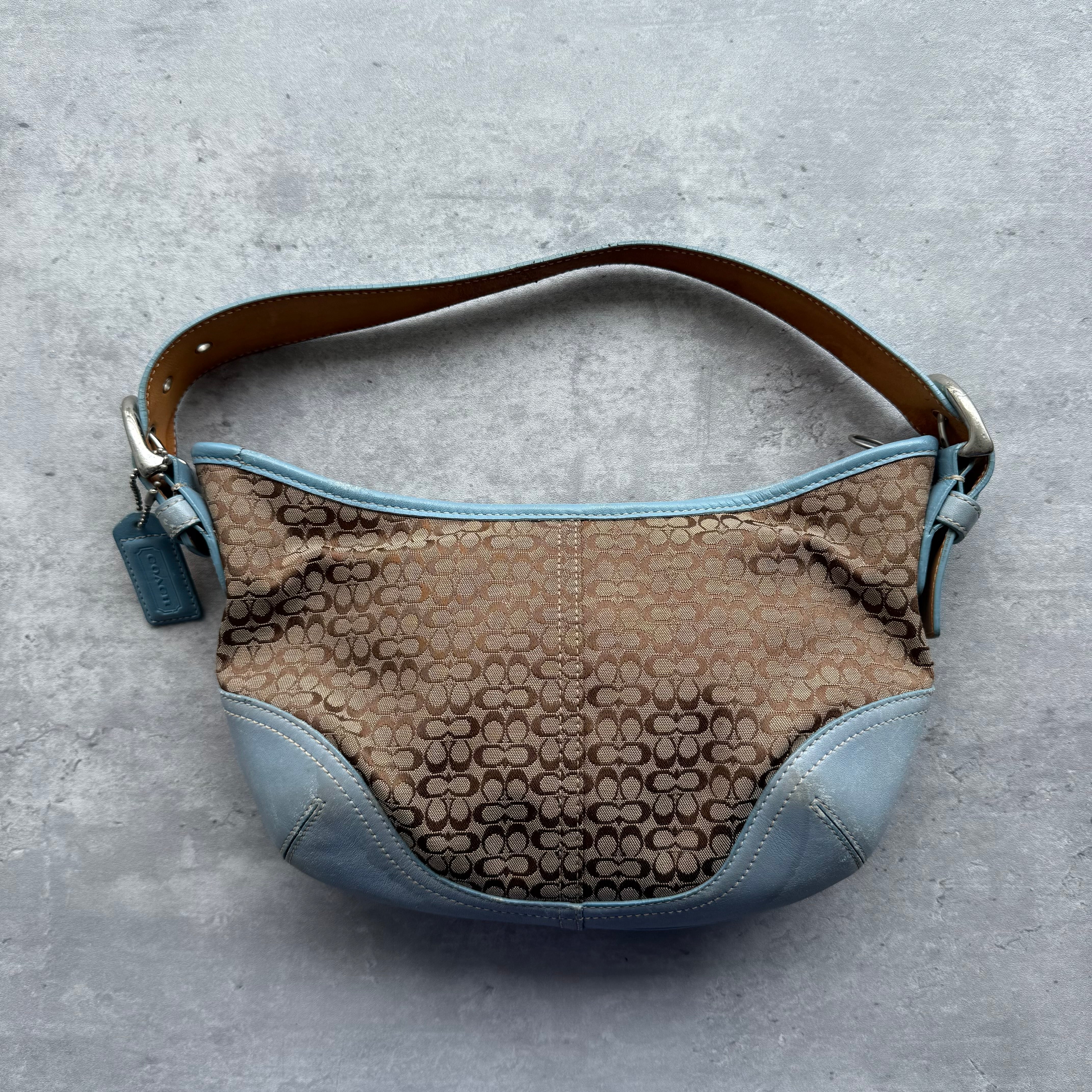 Coach Signature Mini Sufflette Shoulder Bag in beige jacquard with blue leather trim, adjustable strap, and blue fabric lining.