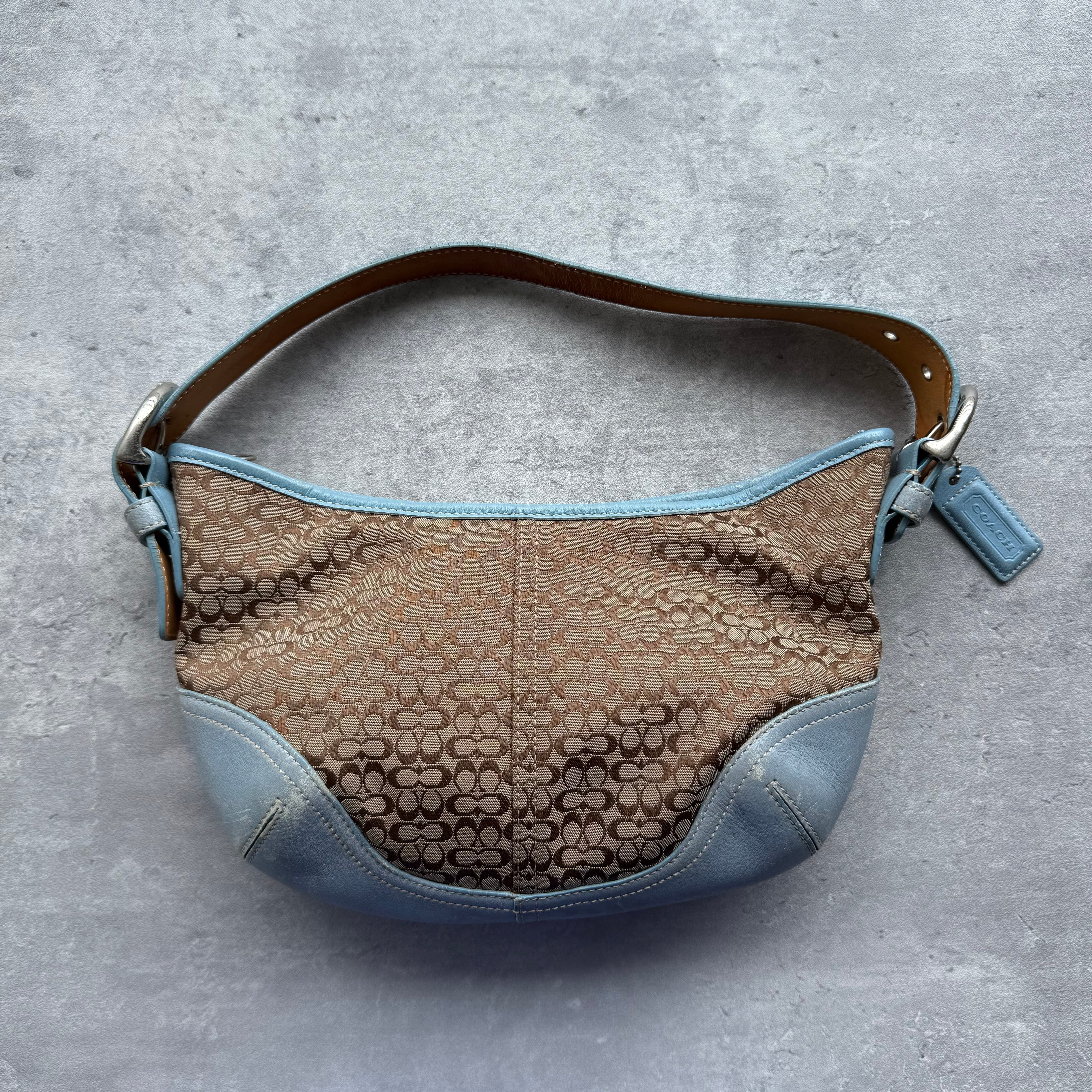Coach Signature Mini Sufflette Shoulder Bag in beige jacquard with blue leather trim, adjustable strap, and blue fabric lining.